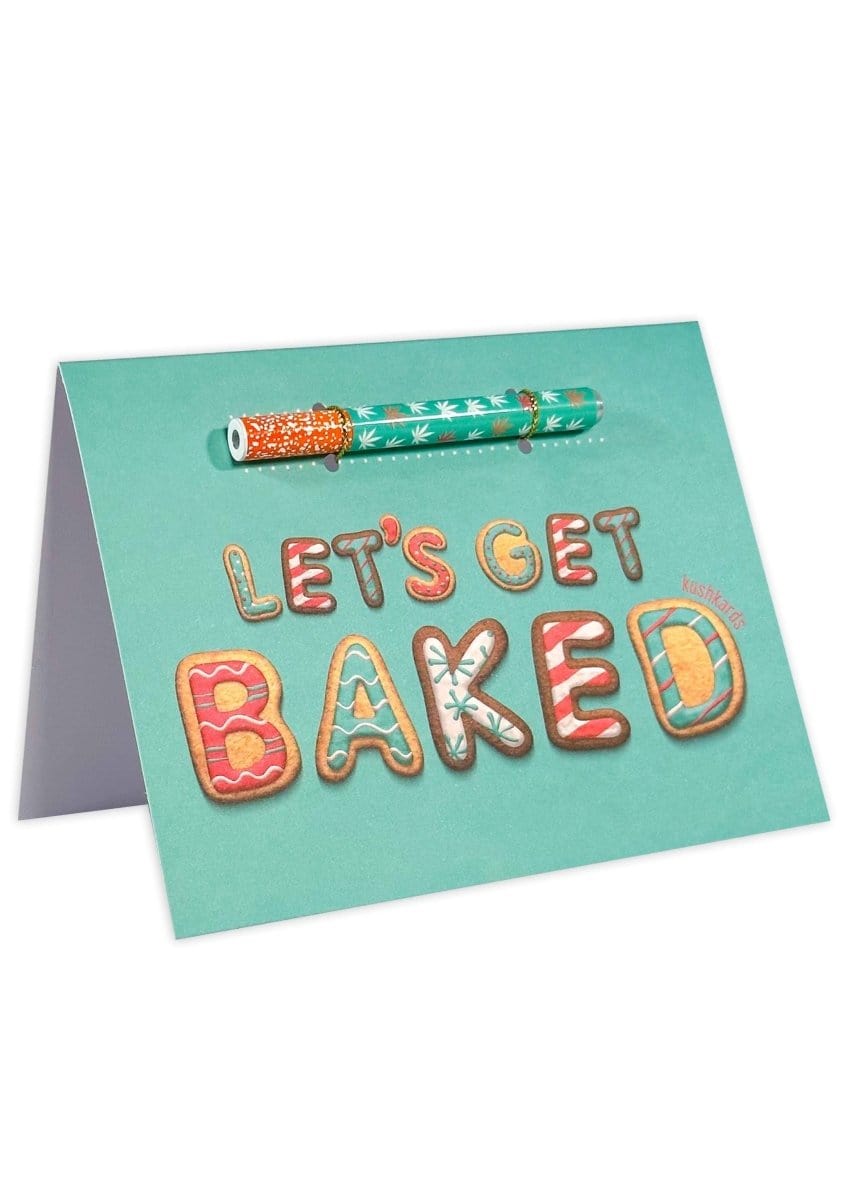 A flat lay of the 🍪 Let's Get Baked Cannabis Greeting Card with a playful cookie illustration on a white surface.