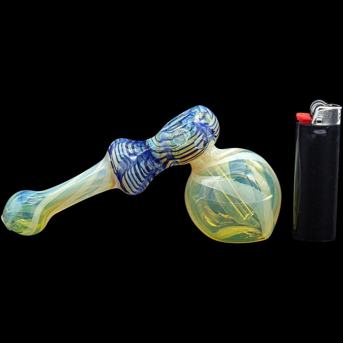 A side view of the “Raked Hammer” Fumed Hammer Bubbler Pipe, showing the colorful glass curves next to a lighter.