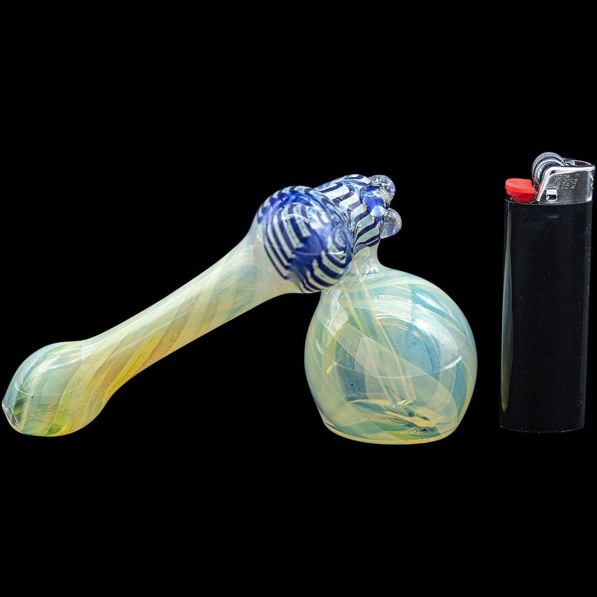 A side view of the “Raked Sidecar” Fumed Sidecar Bubbler Pipe, showcasing its colorful glass swirl next to a lighter.
