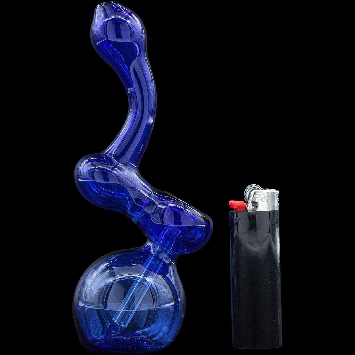A side view of the “Sherbub” Glass Sherlock Bubbler Pipe, presented with a blue tint next to a silver lighter.