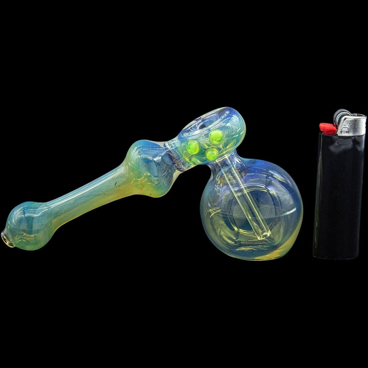 A side view of the “Silver Hammer” Fumed Hammer Bubbler Pipe, showcasing its colorful glass and compact design next to a lighter.