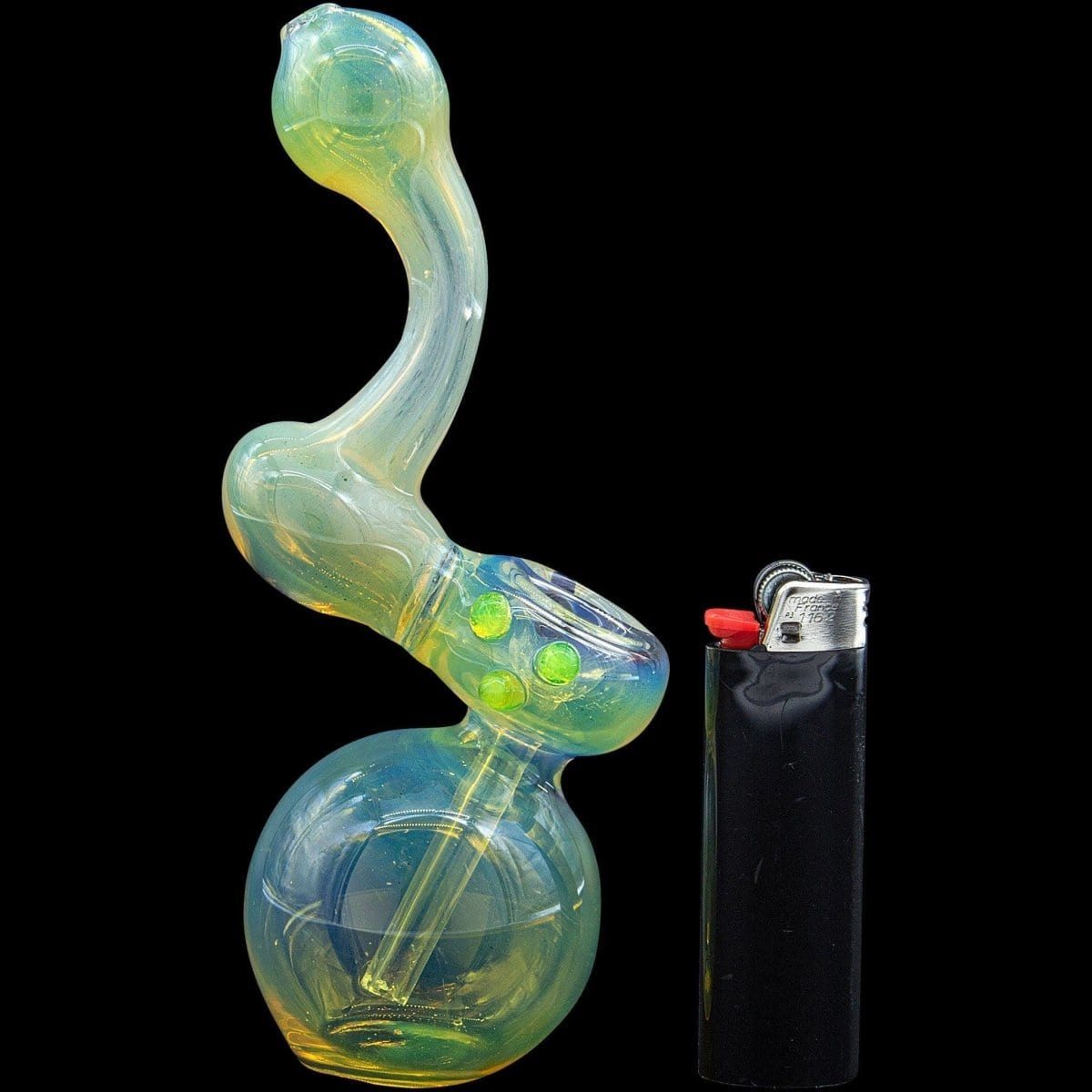 A side view of the “Silver Sherlock” Fumed Sherlock Bubbler Pipe, showing its curved neck and colorful, fume-treated glass next to a lighter.