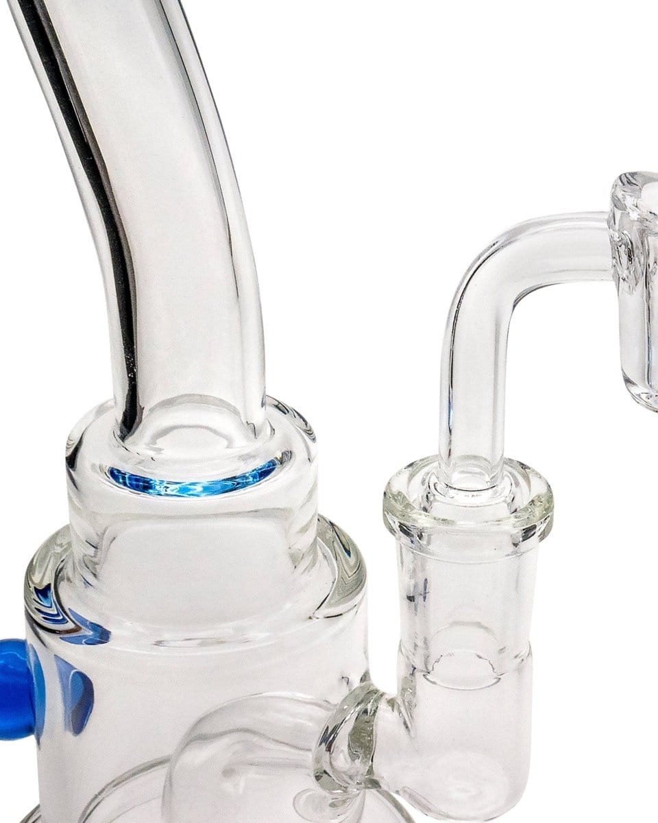 A close-up, angled view of the Layer Cake Color Accented Dab Rig, showcasing its clear glass construction and colorful accents.