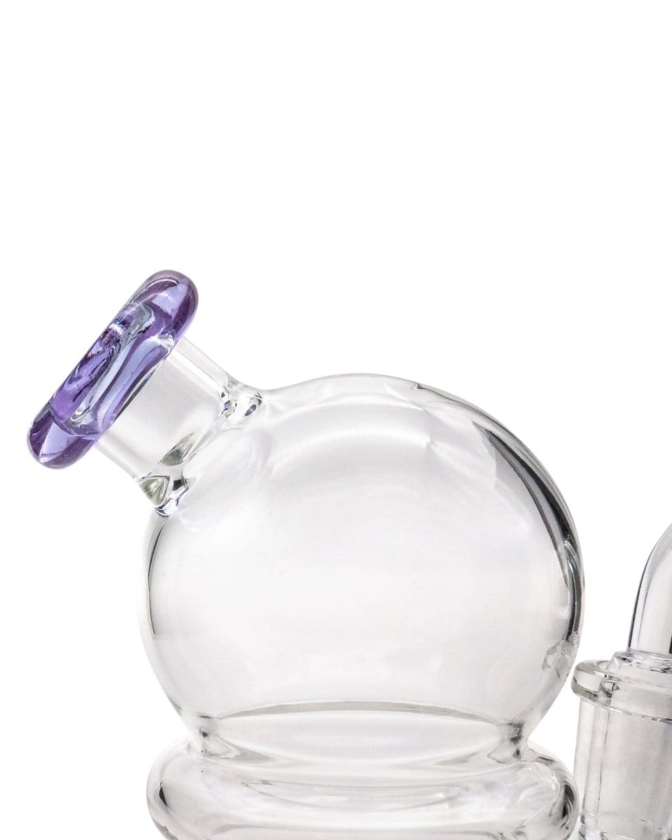 A close-up, angled view of the Nano Globe Rig, showcasing its clear glass construction and smooth, rounded shape.