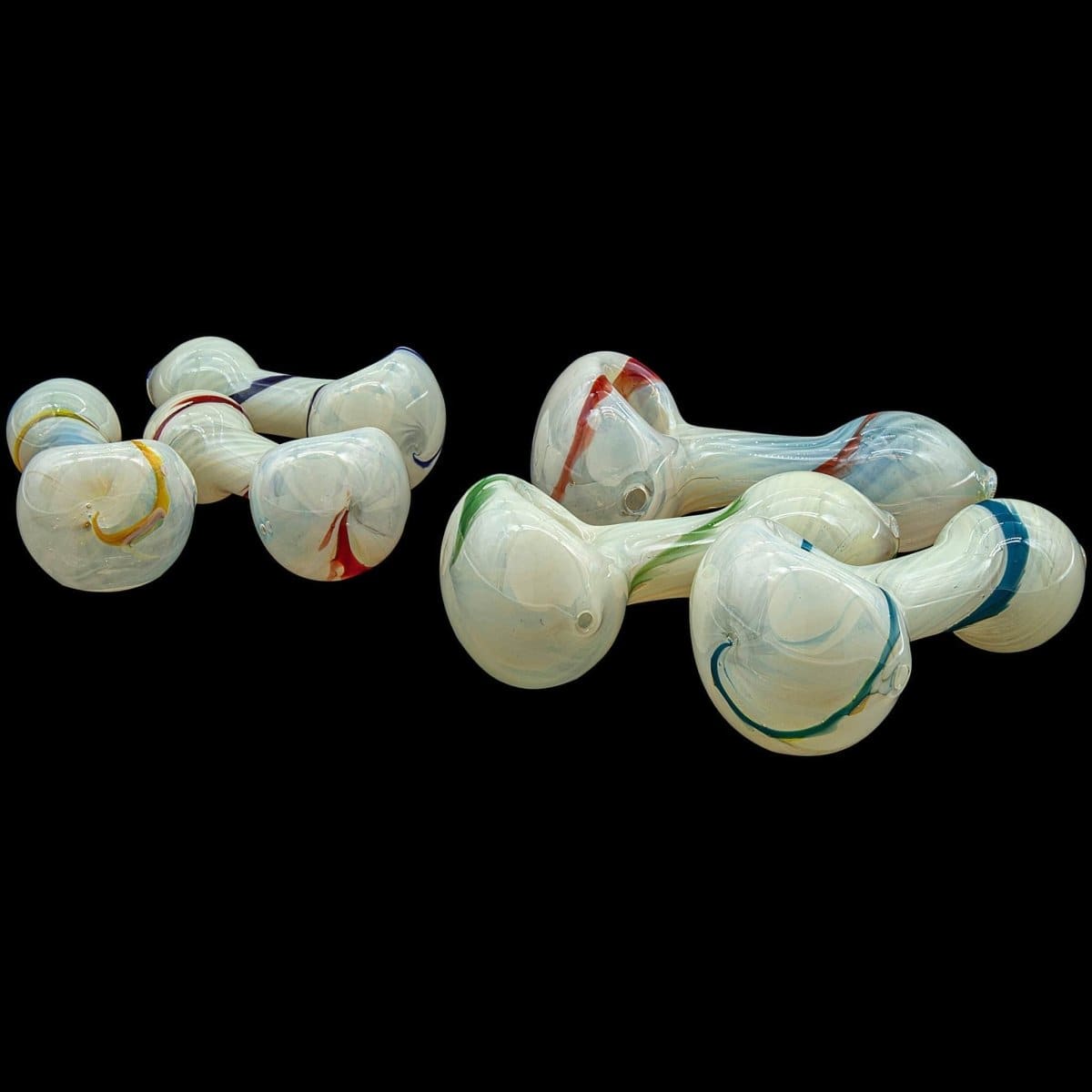 A close-up, angled view of the white "Bones" Spoon Pipe, showcasing its simple, curved design against a dark background.