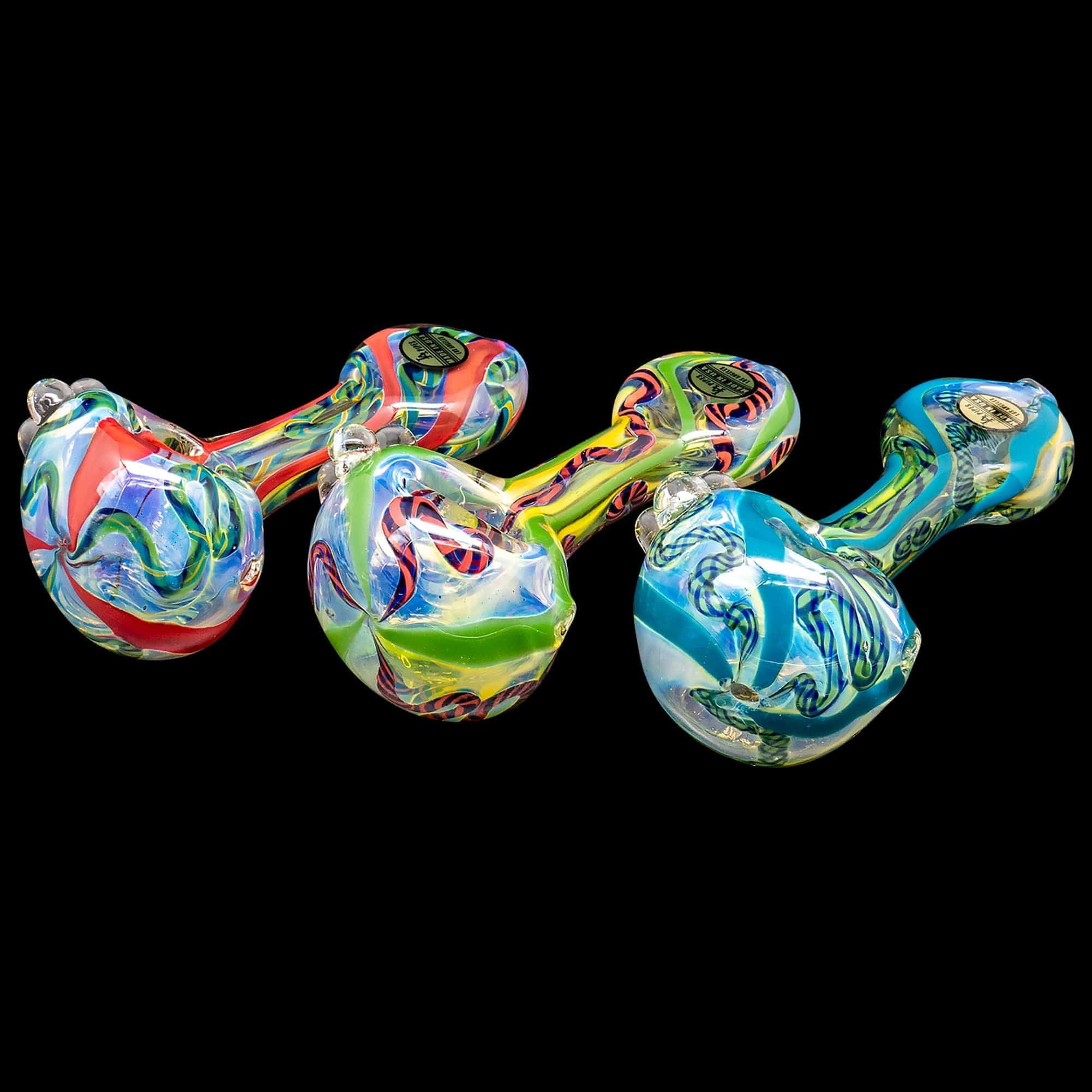 A vibrant, angled view of the “Candy Spoon” Inside-Out Color Changing Glass Pipe, showcasing its swirling, translucent colors.