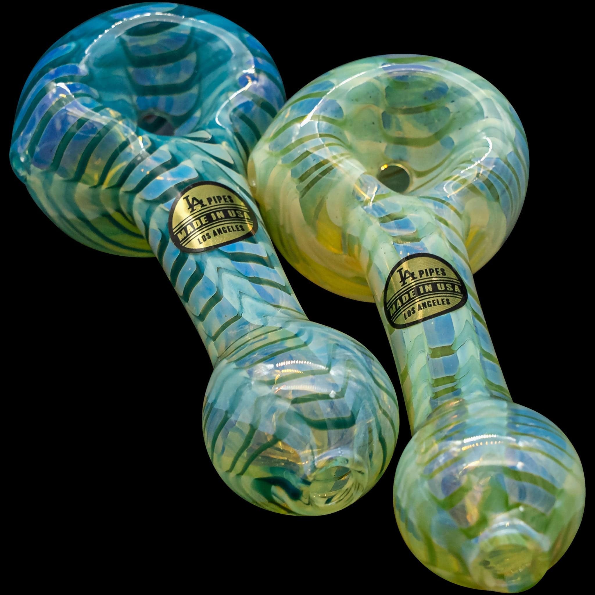 A close-up, angled view of the "Raker" Glass Spoon Pipe, showcasing its colorful swirl pattern and smooth glass finish.