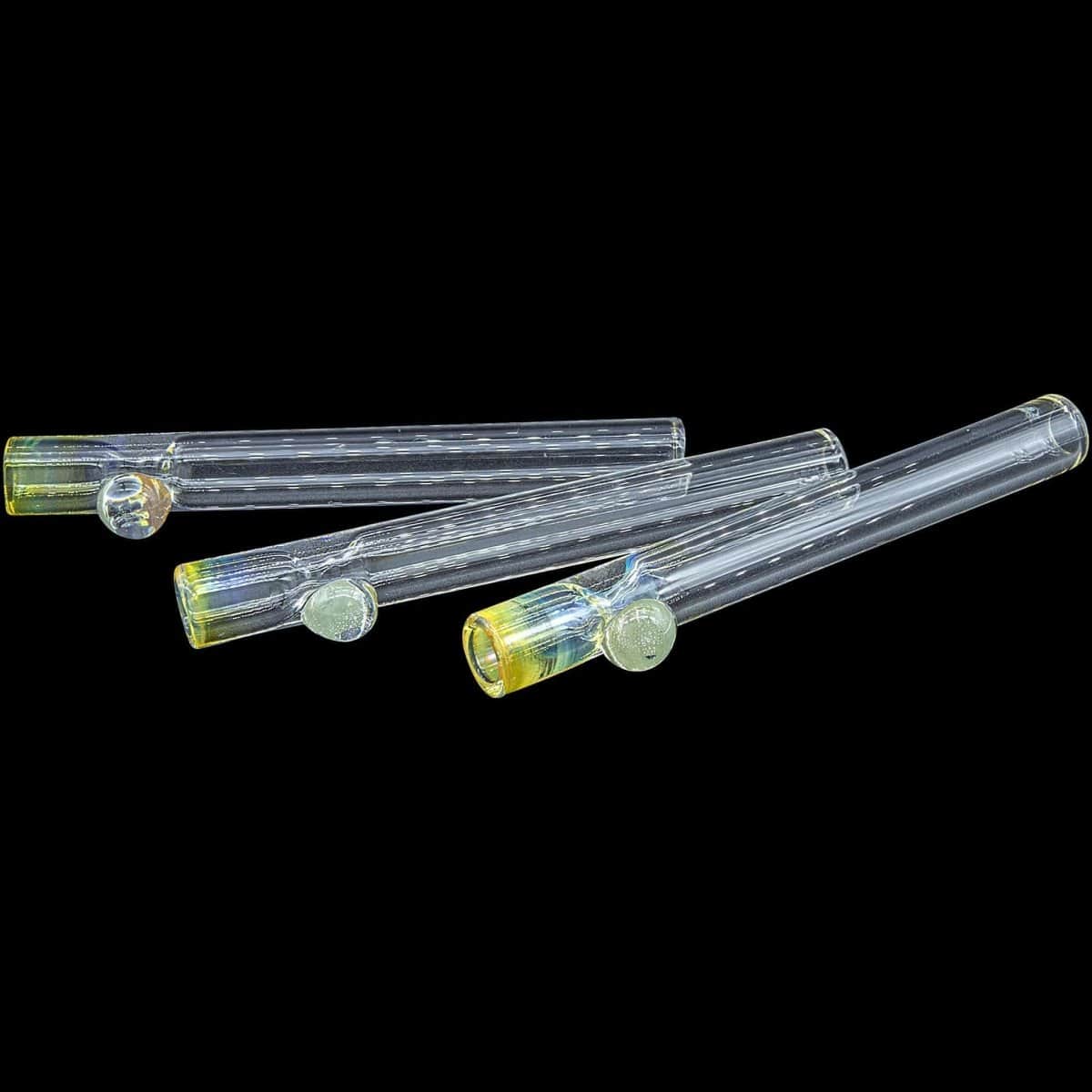 A slightly angled view of the “One Hitter Never Quitter” glass one-hitter, showing its simple, cylindrical shape against a dark background.