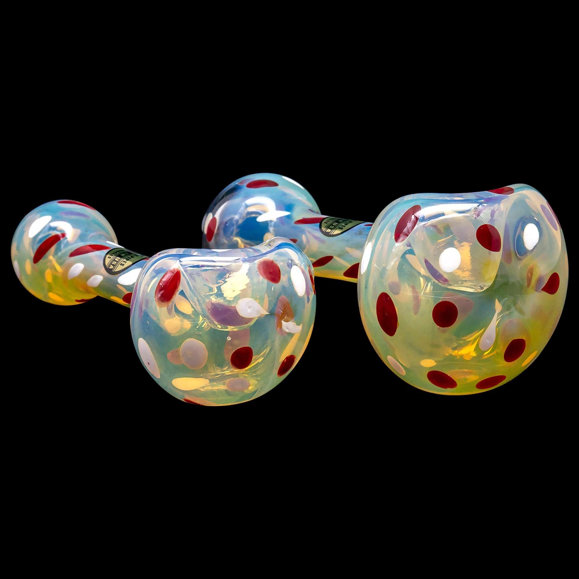 A close-up, angled view of the “Polka Dot” Glass Spoon Pipe, showcasing its colorful speckled pattern against a black background.