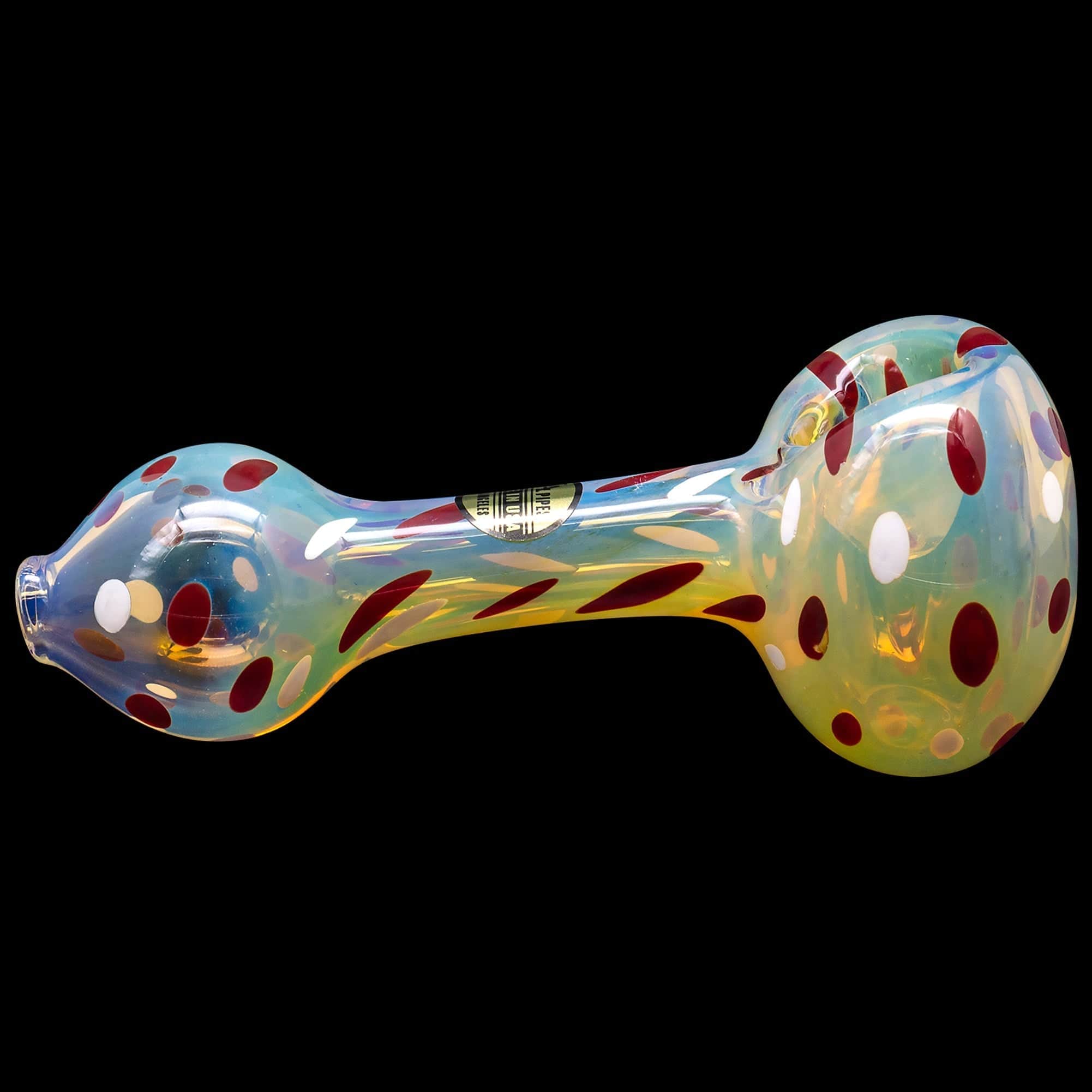 A side view of the “Polka Dot” Glass Spoon Pipe shows a colorful, patterned glass pipe against a black background.