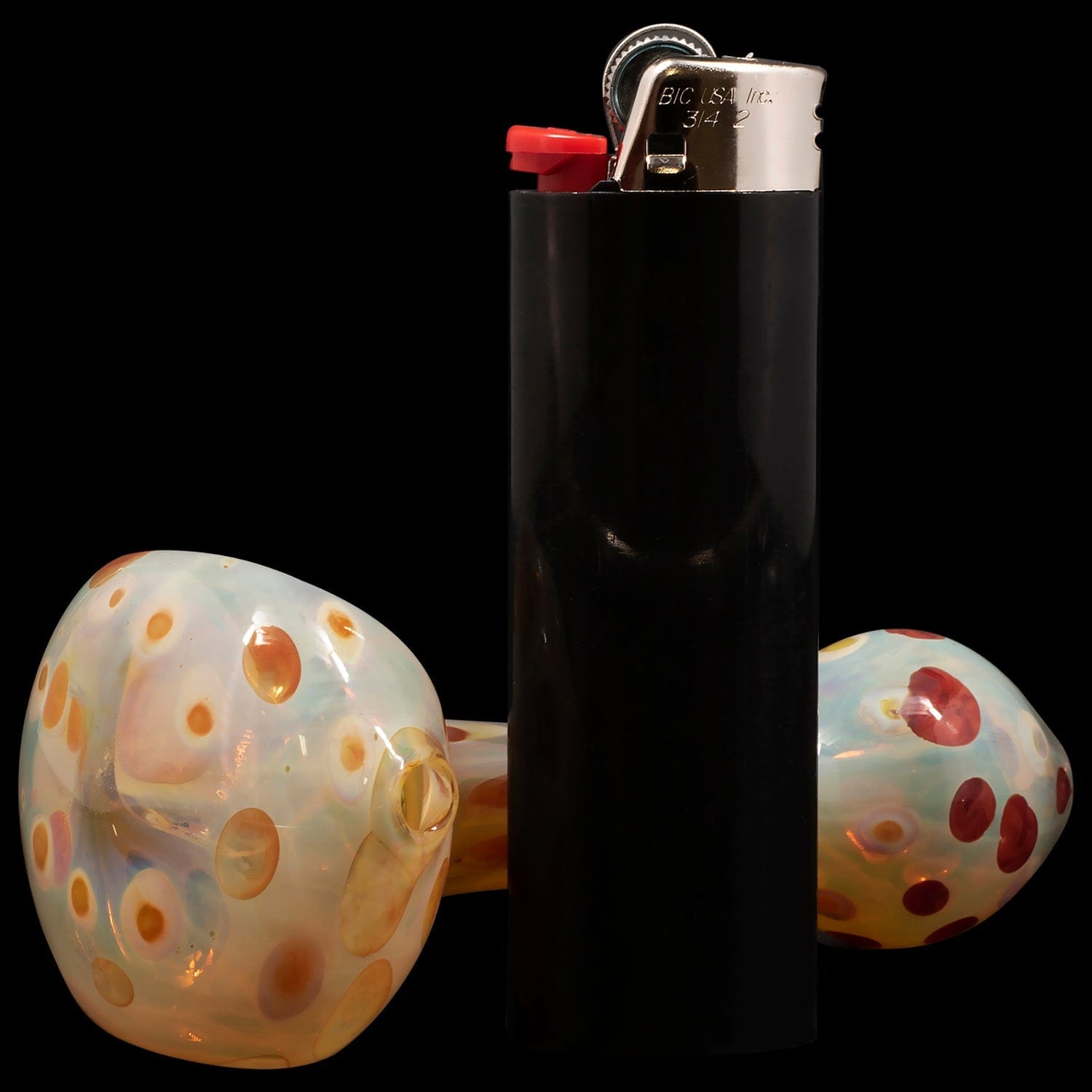 Close-up of the “Polka Dot” Glass Spoon Pipe, displaying a colorful, patterned design against a dark background.