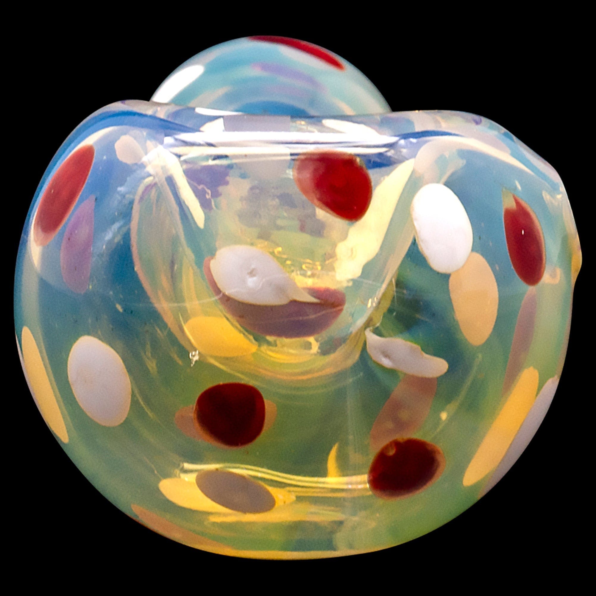 A close-up, angled view of the “Polka Dot” Glass Spoon Pipe, featuring colorful polka dots against a clear glass background.