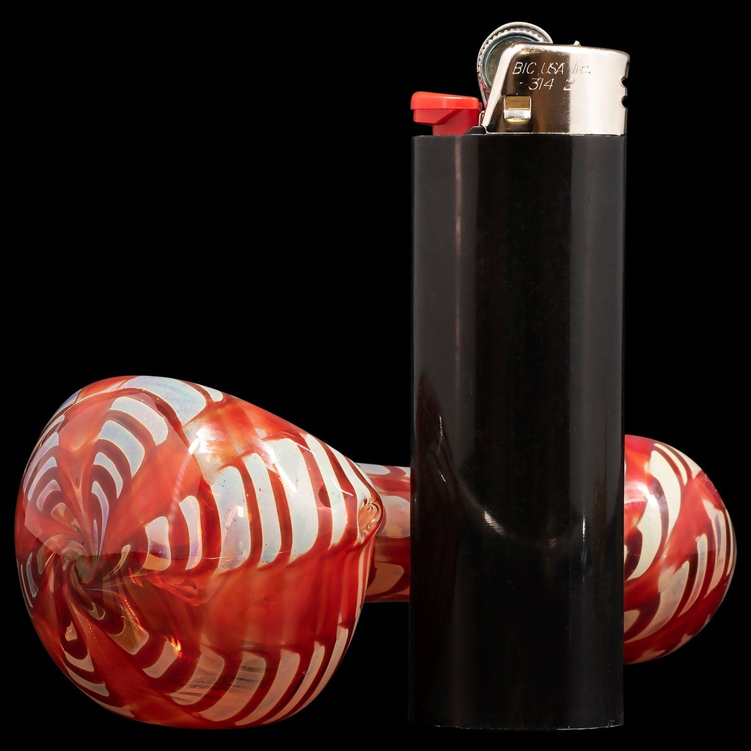 A front view of the “Raker” Glass Spoon Pipe, highlighting its curved form against a dark backdrop.