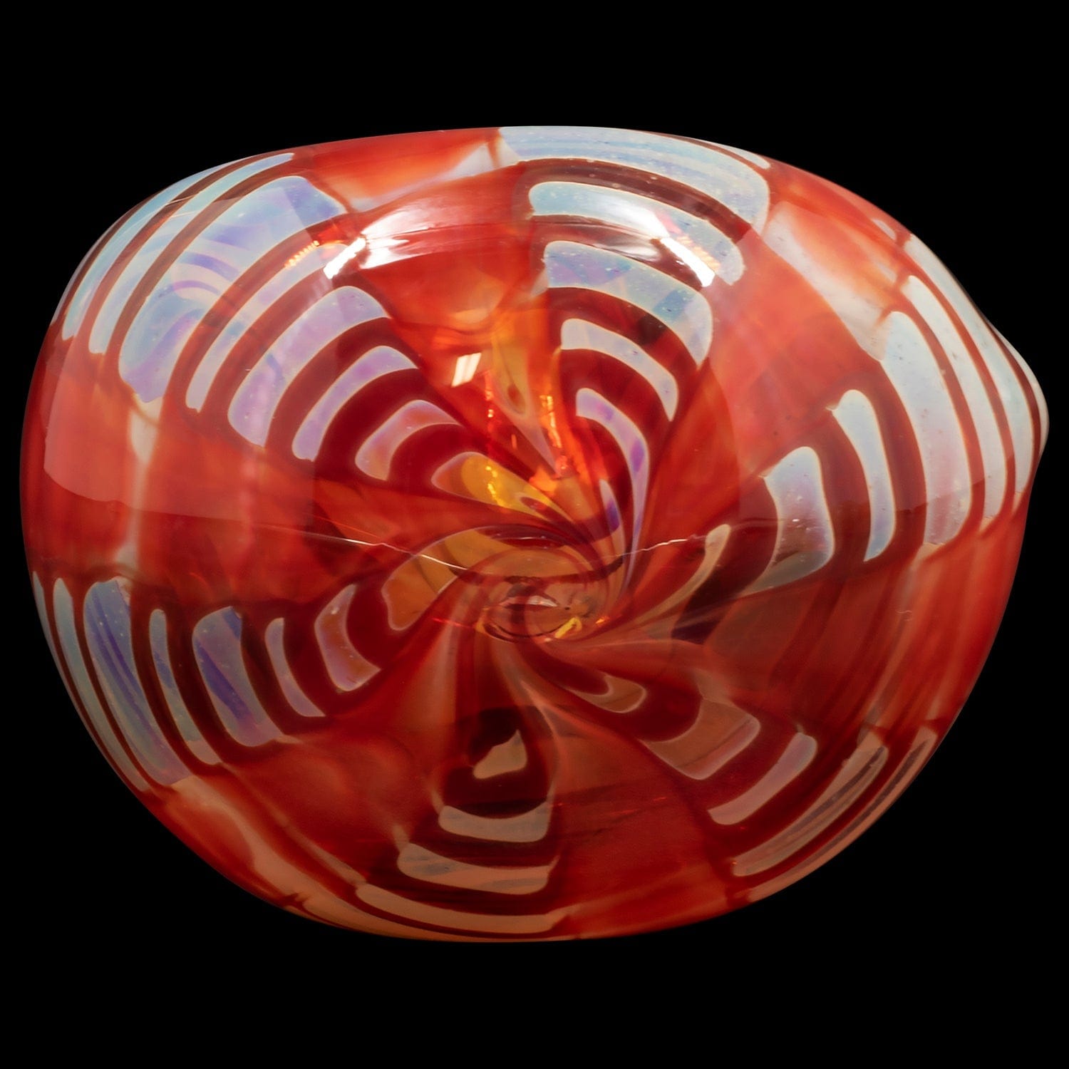 A close-up, angled view of the “Raker” Glass Spoon Pipe, showcasing its curved design and vibrant red glass.