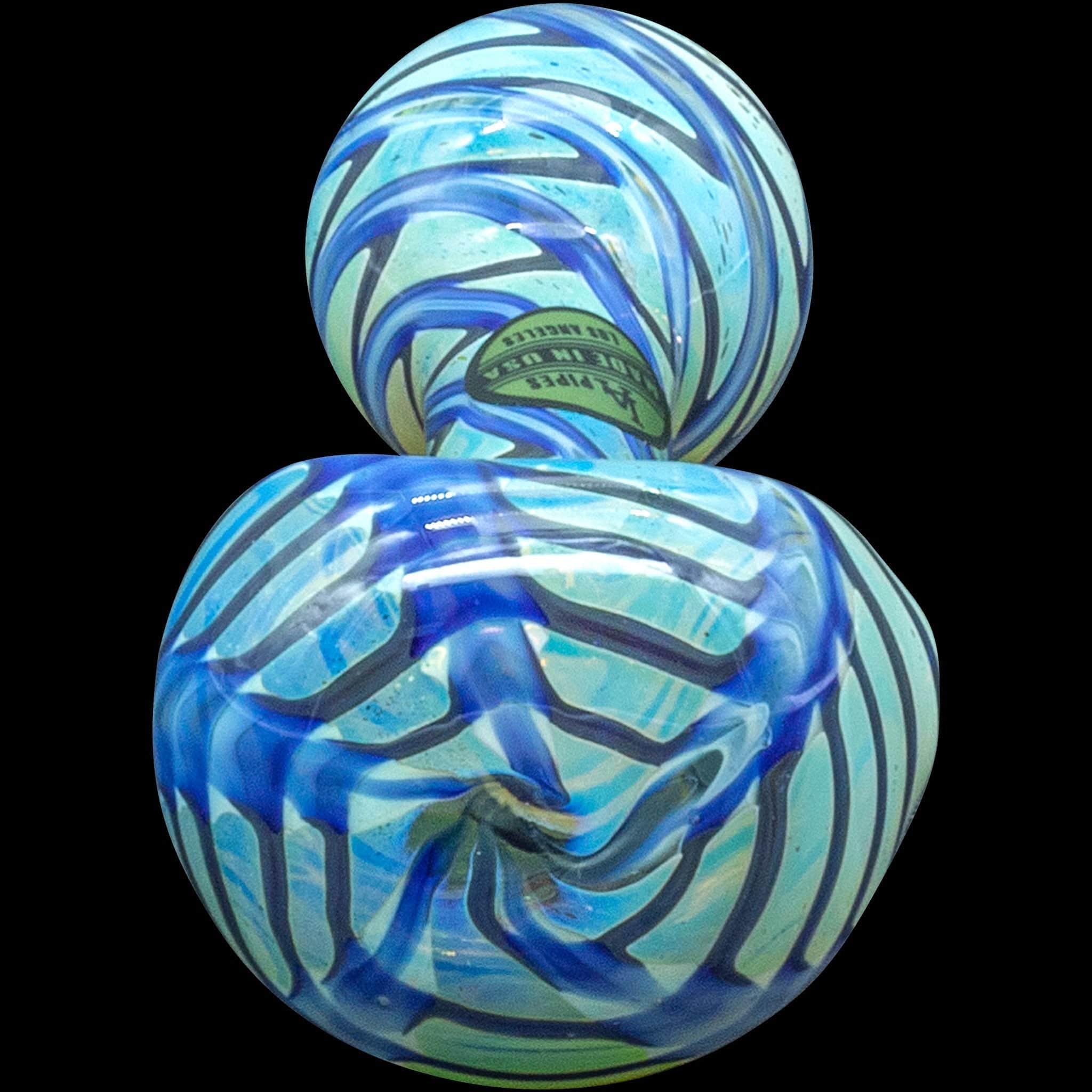 A close-up view of the “Raker” Glass Spoon Pipe, showcasing its colorful, swirled glass design against a dark background.