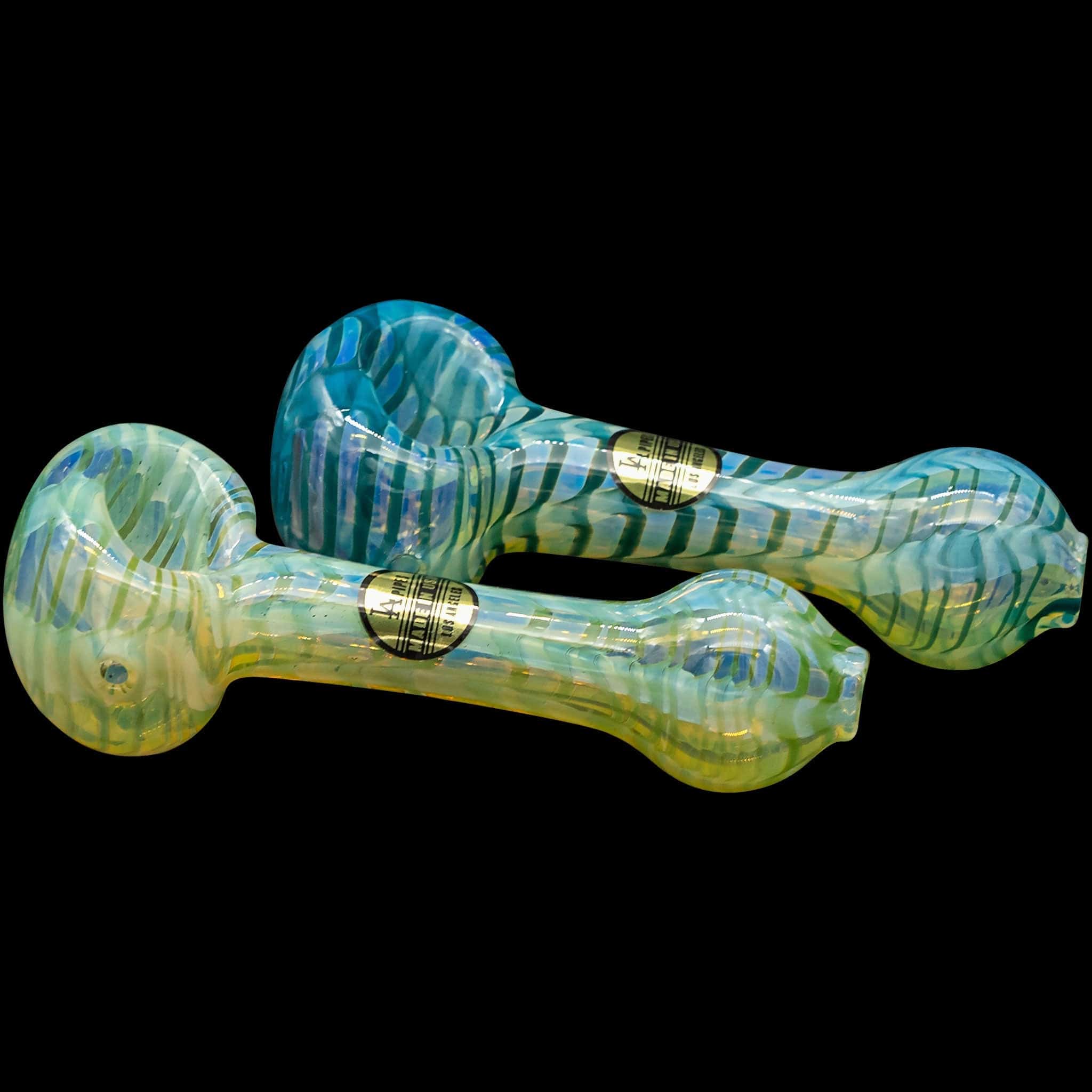 A detailed view of the "Raker" Glass Spoon Pipe, showing the swirling blue and green glass design against a black background.