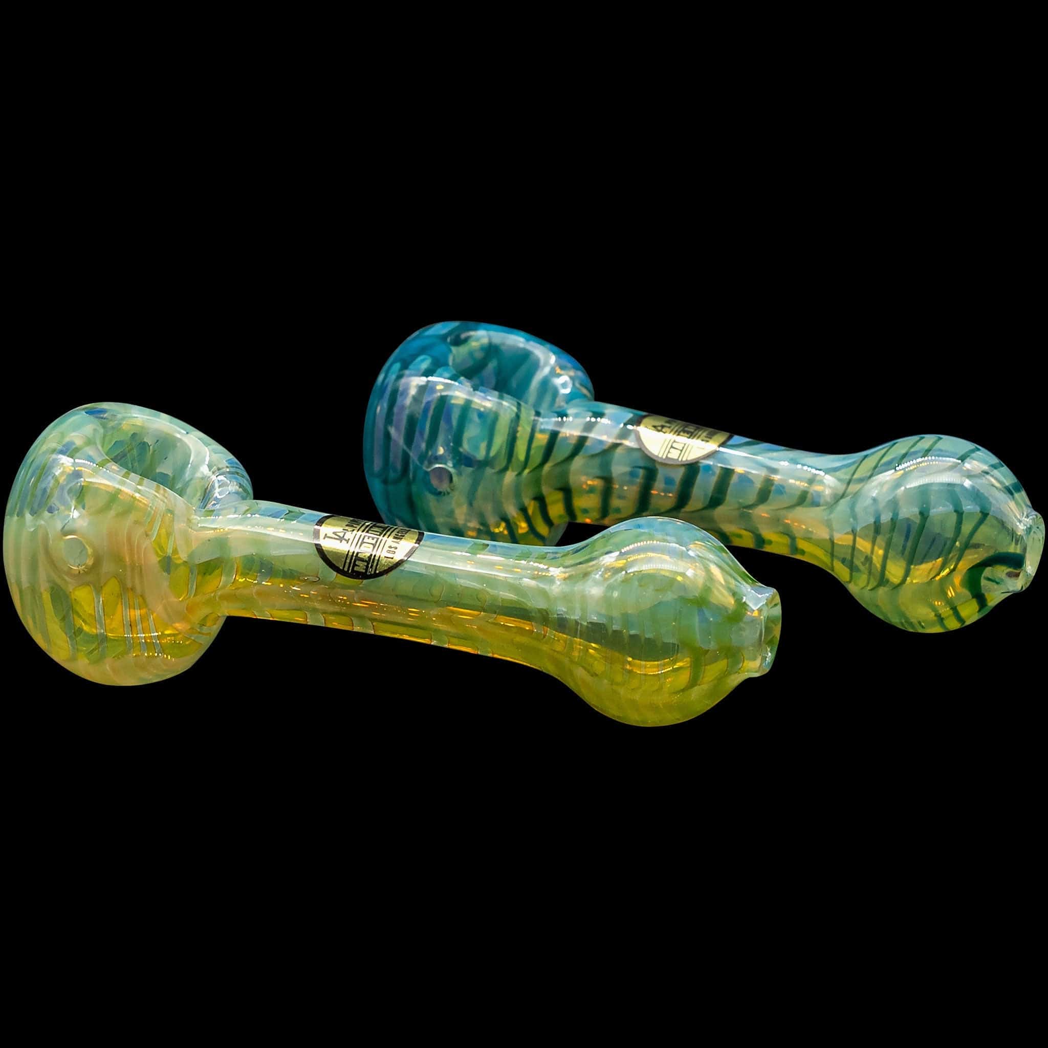 A front view of the “Raker” Glass Spoon Pipe, showcasing its curved shape and detailed glasswork on a black background.