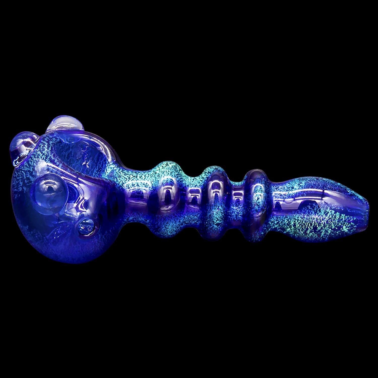 A side view of the “Ringed Maria” Dichro Spoon Pipe, showing a colorful, patterned glass pipe with a rounded bowl.