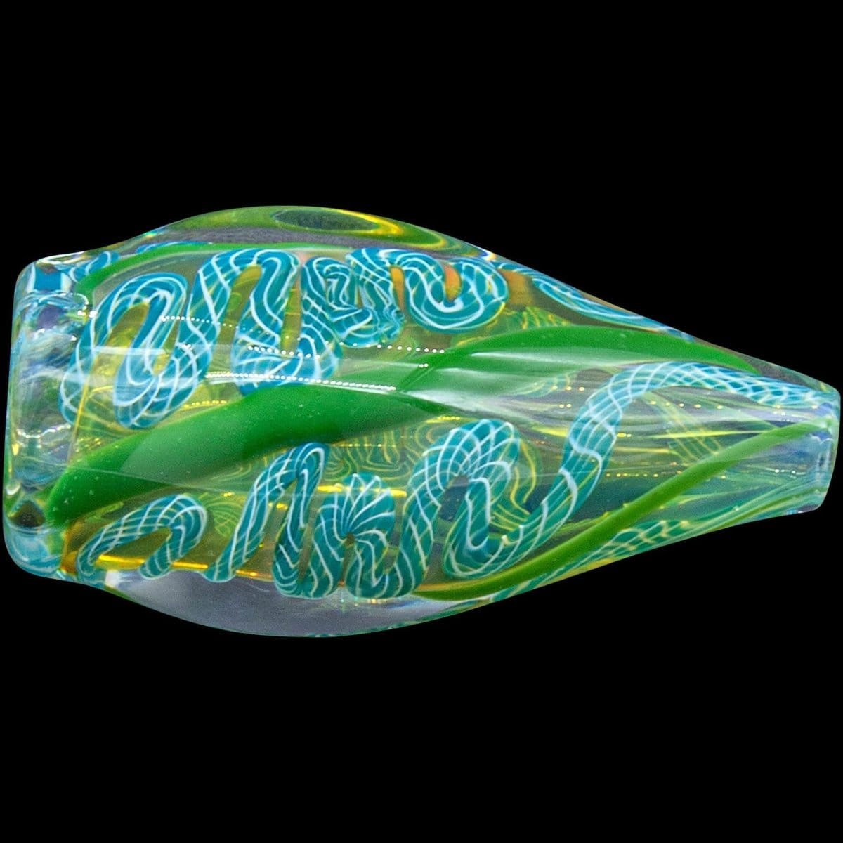 A detailed, angled view of the “Skipping Stone” Inside-Out Chillum, showcasing its intricate glasswork and translucent green hue.