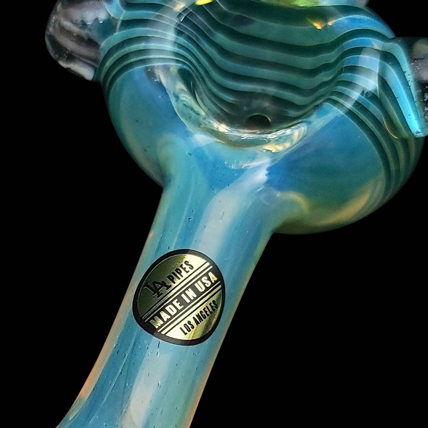 A close-up view of the “Spiral Marble Head” Glass Spoon Pipe, showing a marbled pattern in shades of blue and white.