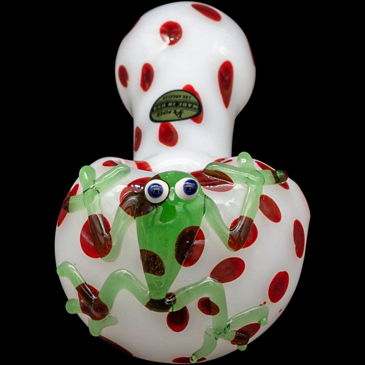 Front view of the “Spotted Poison Frog” Spoon Glass Pipe, showcasing its vibrant, speckled design against a dark backdrop.