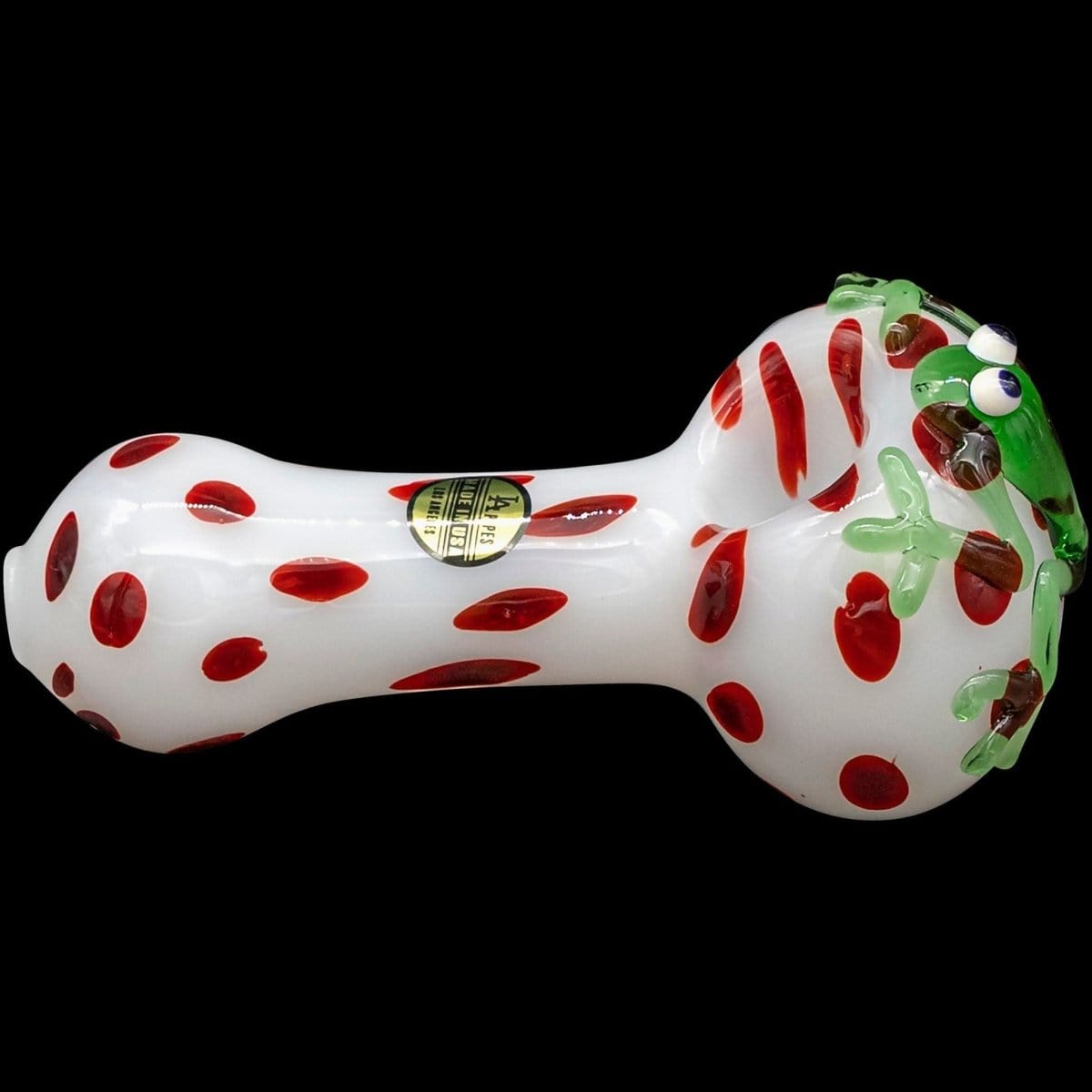 A side view of the “Spotted Poison Frog” Spoon Glass Pipe with a colorful, patterned design against a dark backdrop.