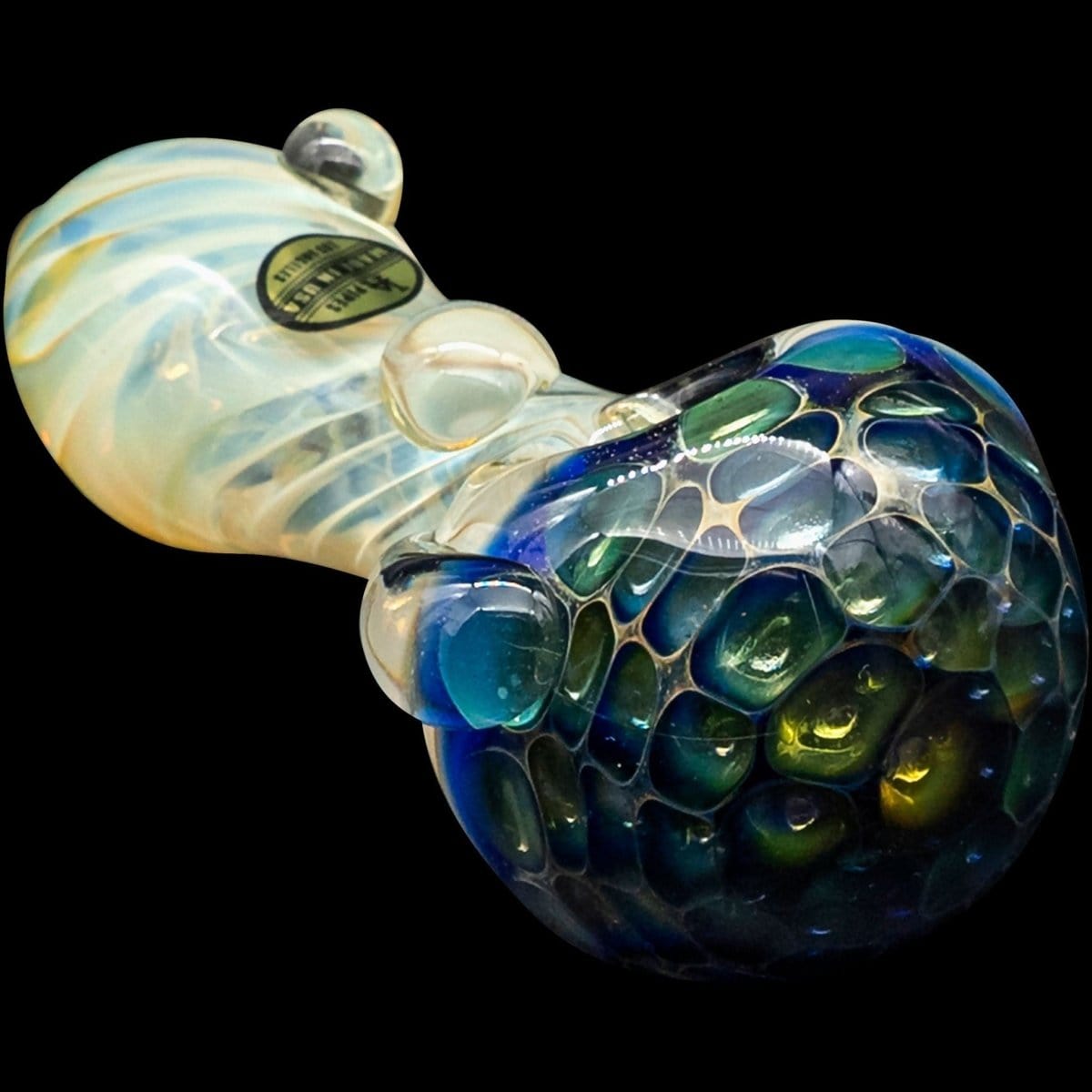 A close-up, angled view of “The Hive” Honeycomb Color Changing Glass Pipe, showcasing its textured glass and vibrant hues.