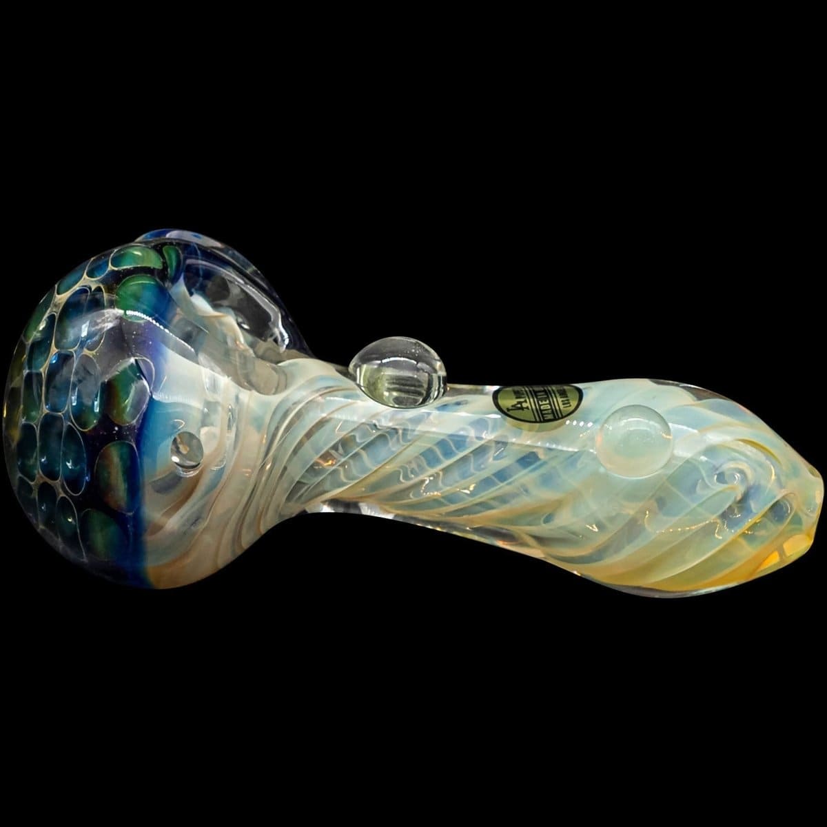 A slightly angled view of “The Hive” Honeycomb Color Changing Glass Pipe, displaying a vibrant, patterned glass design.
