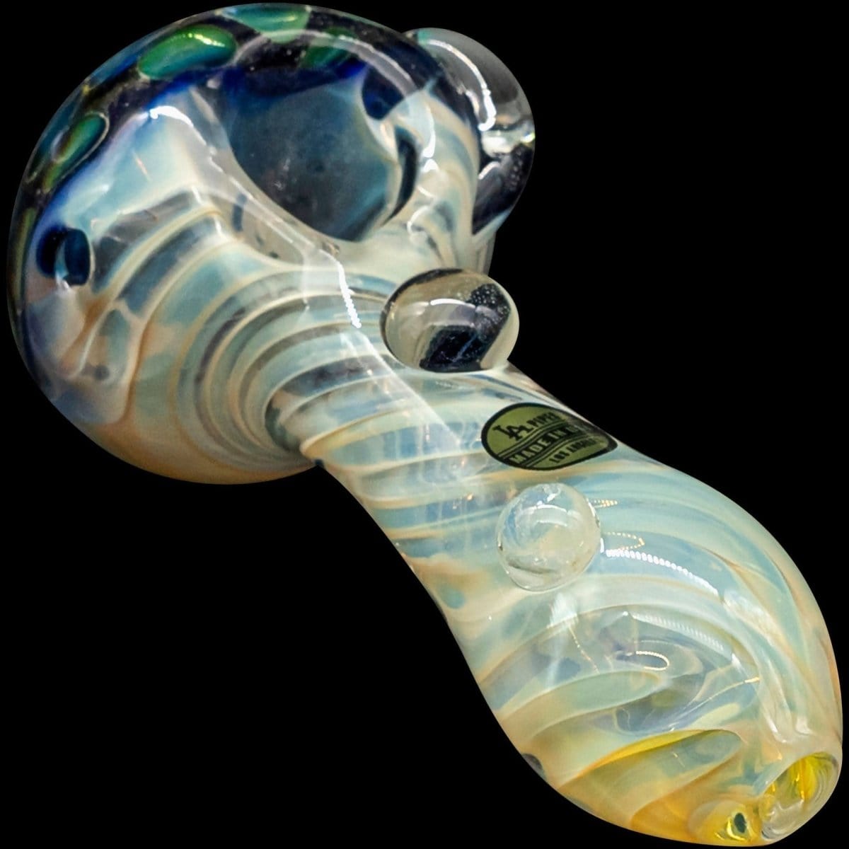 A close-up view of “The Hive” Honeycomb Color Changing Glass Pipe, showcasing its iridescent, swirling colors.