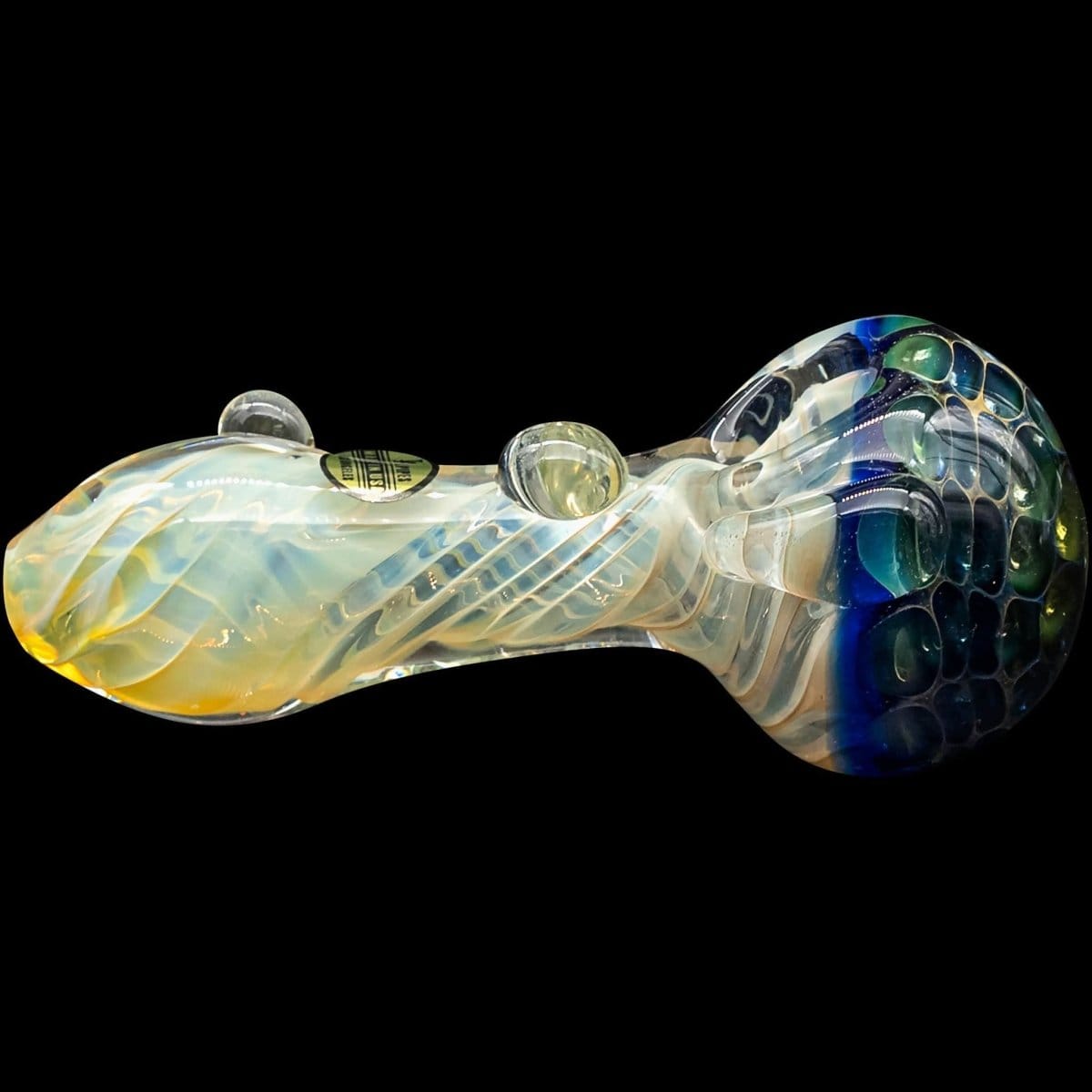A close-up, angled view of “The Hive” Honeycomb Color Changing Glass Pipe, featuring a rounded bowl and vibrant, shifting hues.