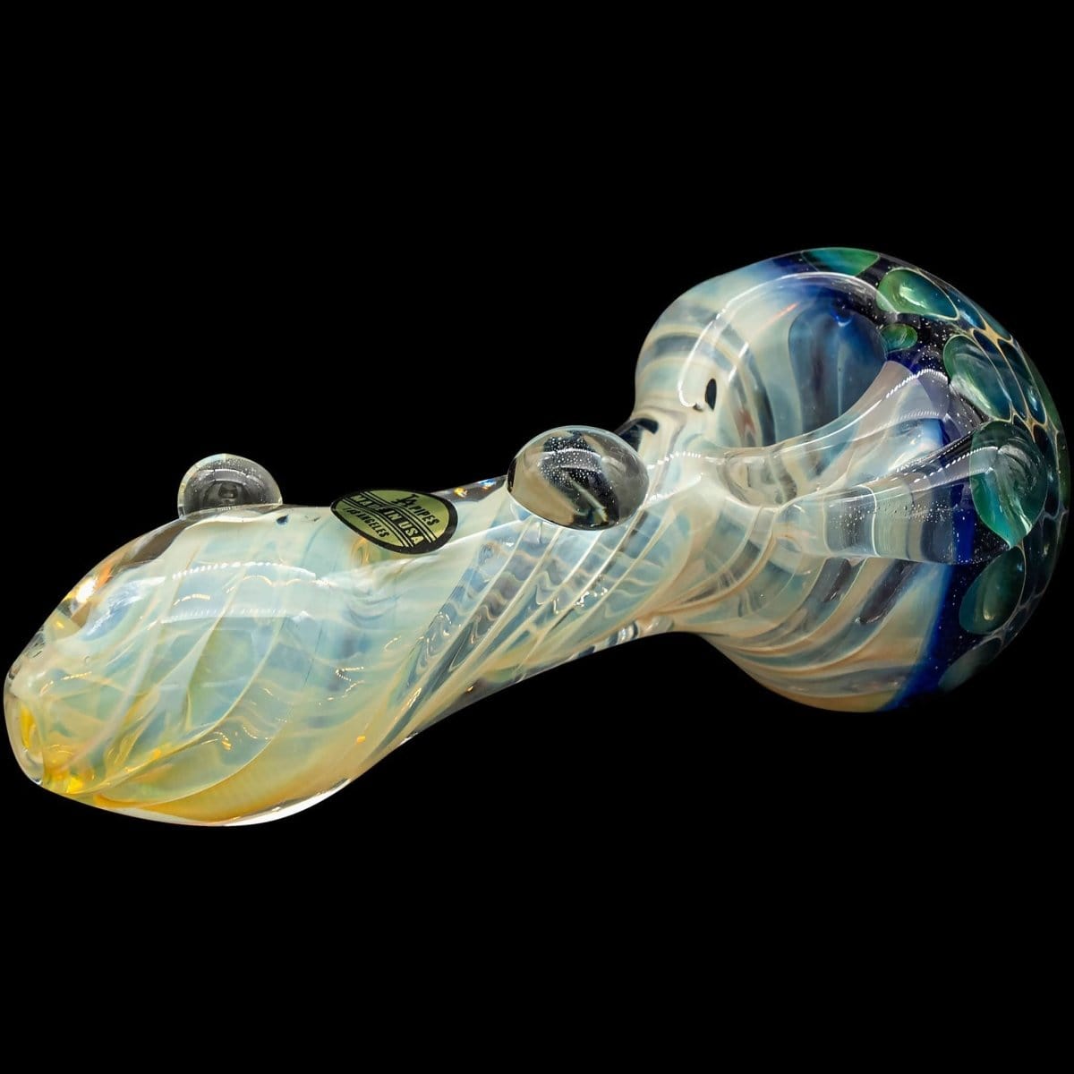 A side view of "The Hive" Honeycomb Color Changing Glass Pipe, showcasing its curved shape and vibrant, shifting colors.