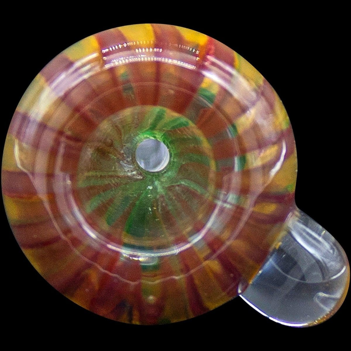Close-up view of the 9mm Rasta Slide Bowl, showcasing its colorful glass construction and circular design.