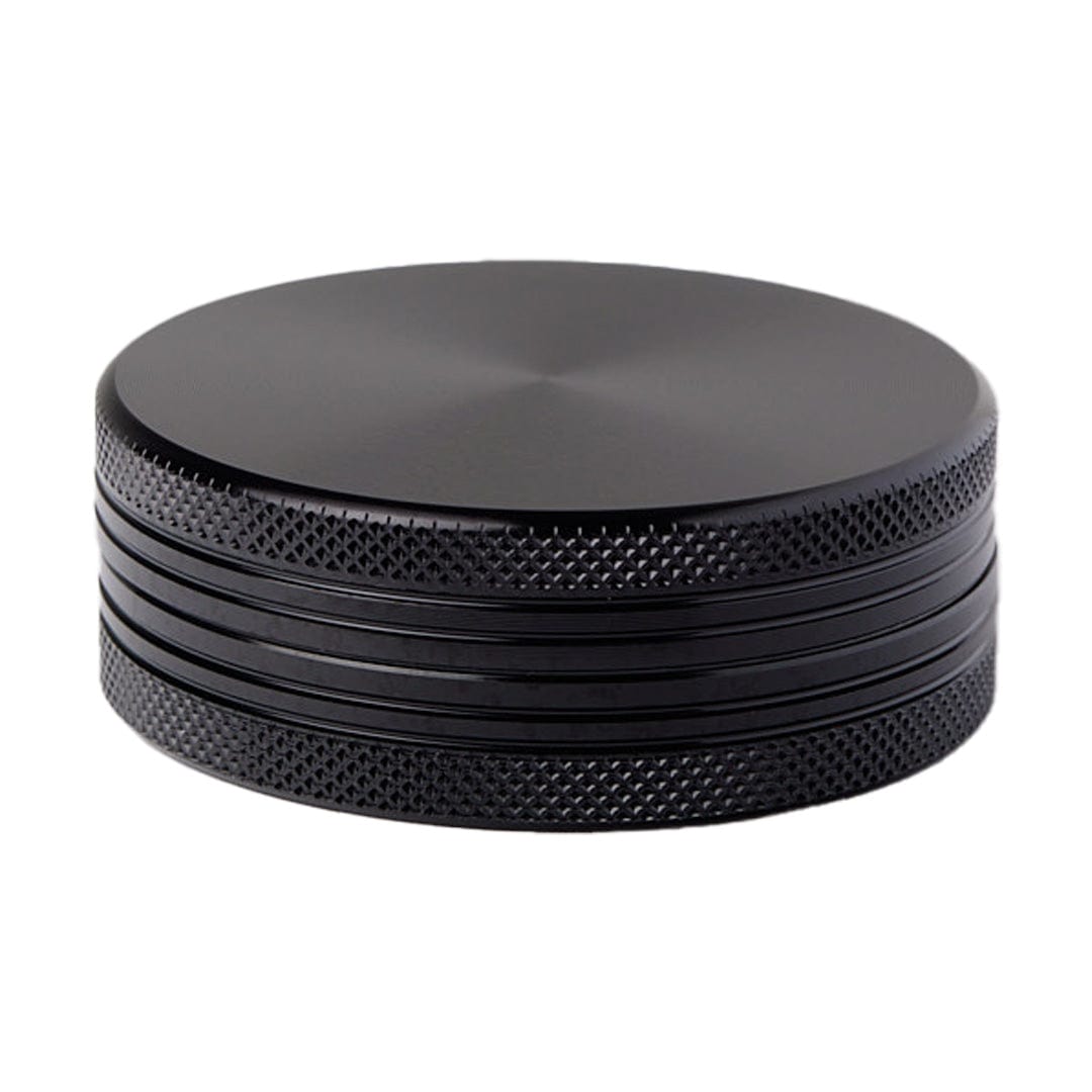 A close-up, angled view of the Meudsa Customs Flat Grinders, showing its stacked, metallic finish.