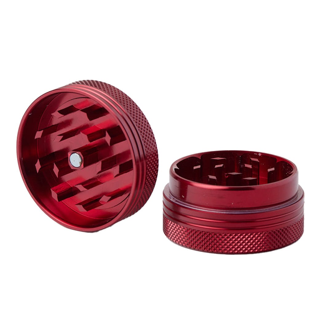 A close-up, angled view of the Meudsa Customs Flat Grinders, showing the metal grinder’s textured surface and open chamber.