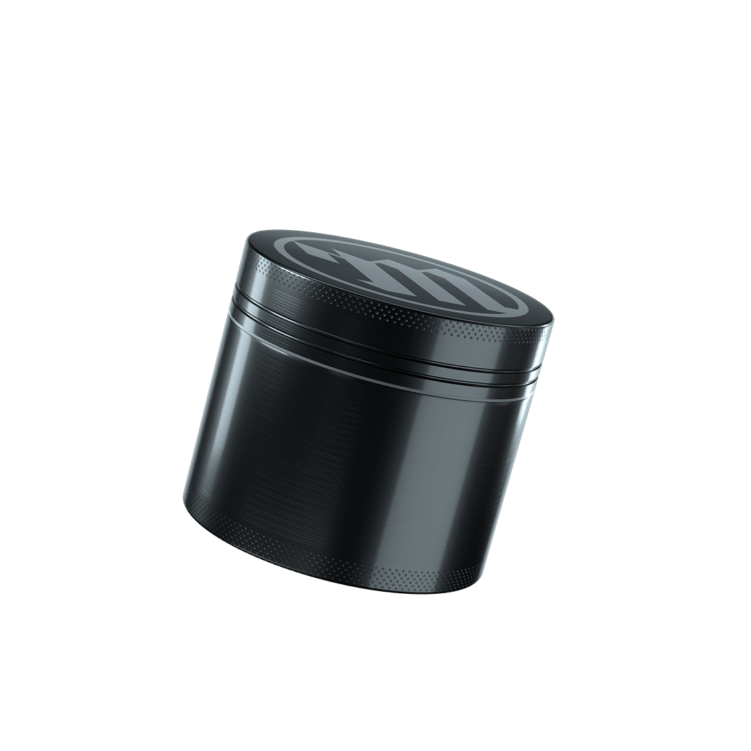 A slightly angled studio shot of the Myster 4-Piece Grinder, showcasing its metallic finish and four-part construction.
