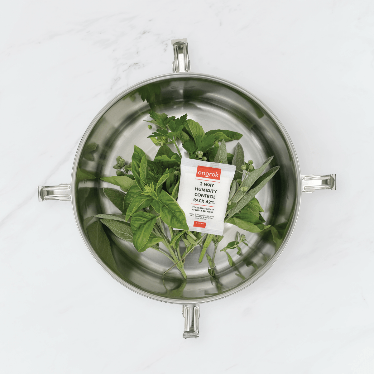 Overhead view of the 2-Way 62% Humidity Packs inside a clear container, showcasing their packaging and small size.