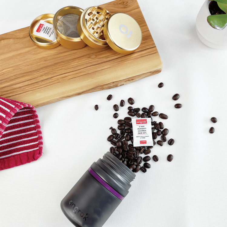 Overhead view of the Child Resistant Glass Storage Jar, filled with dark coffee beans on a light wooden surface.