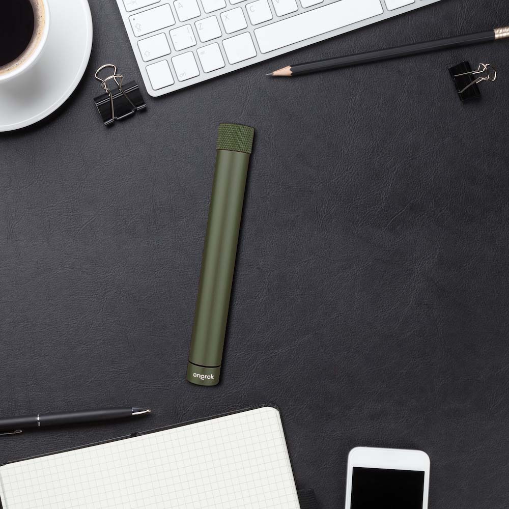 A side view shows the Premium Storage Tube  Single positioned on a desk with a keyboard and clips.