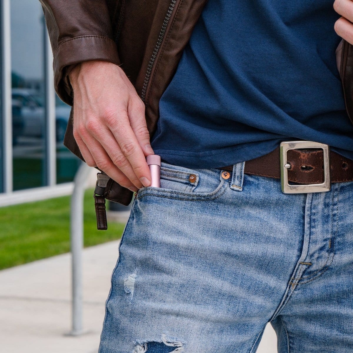 A close-up, angled view shows the Premium Storage Tube  Single subtly peeking from a denim pocket against a blurred background.