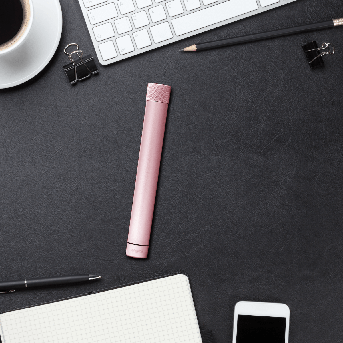 Overhead view of the Premium Storage Tube  Single, positioned next to office supplies on a textured surface.