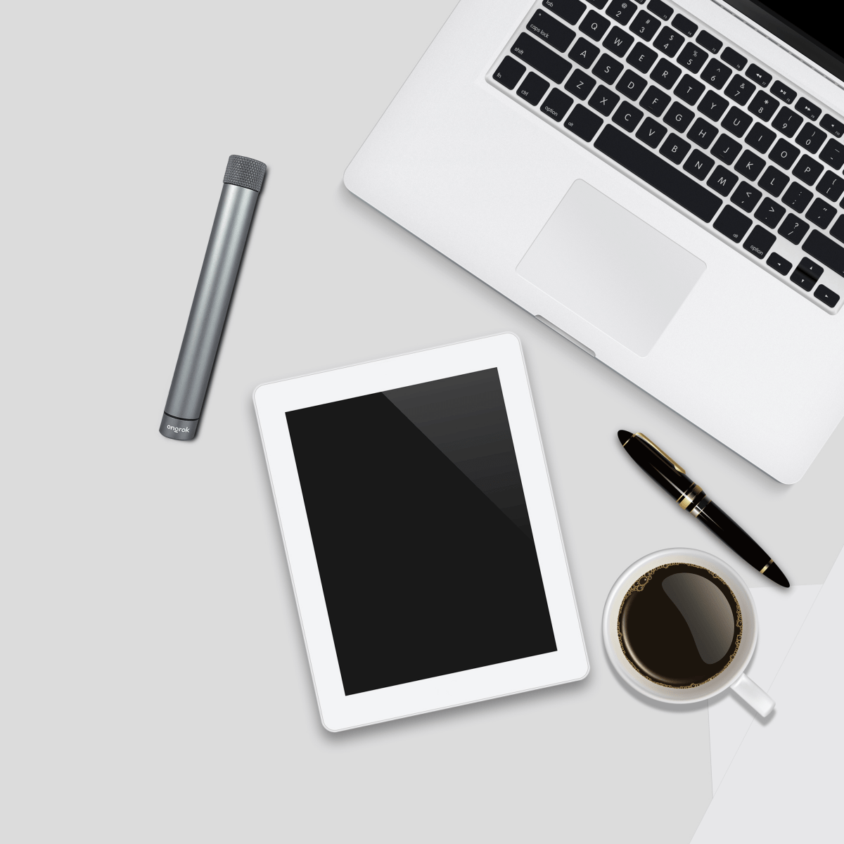 Overhead view of the Premium Storage Tube  Single resting on a desk alongside a pen and coffee cup.