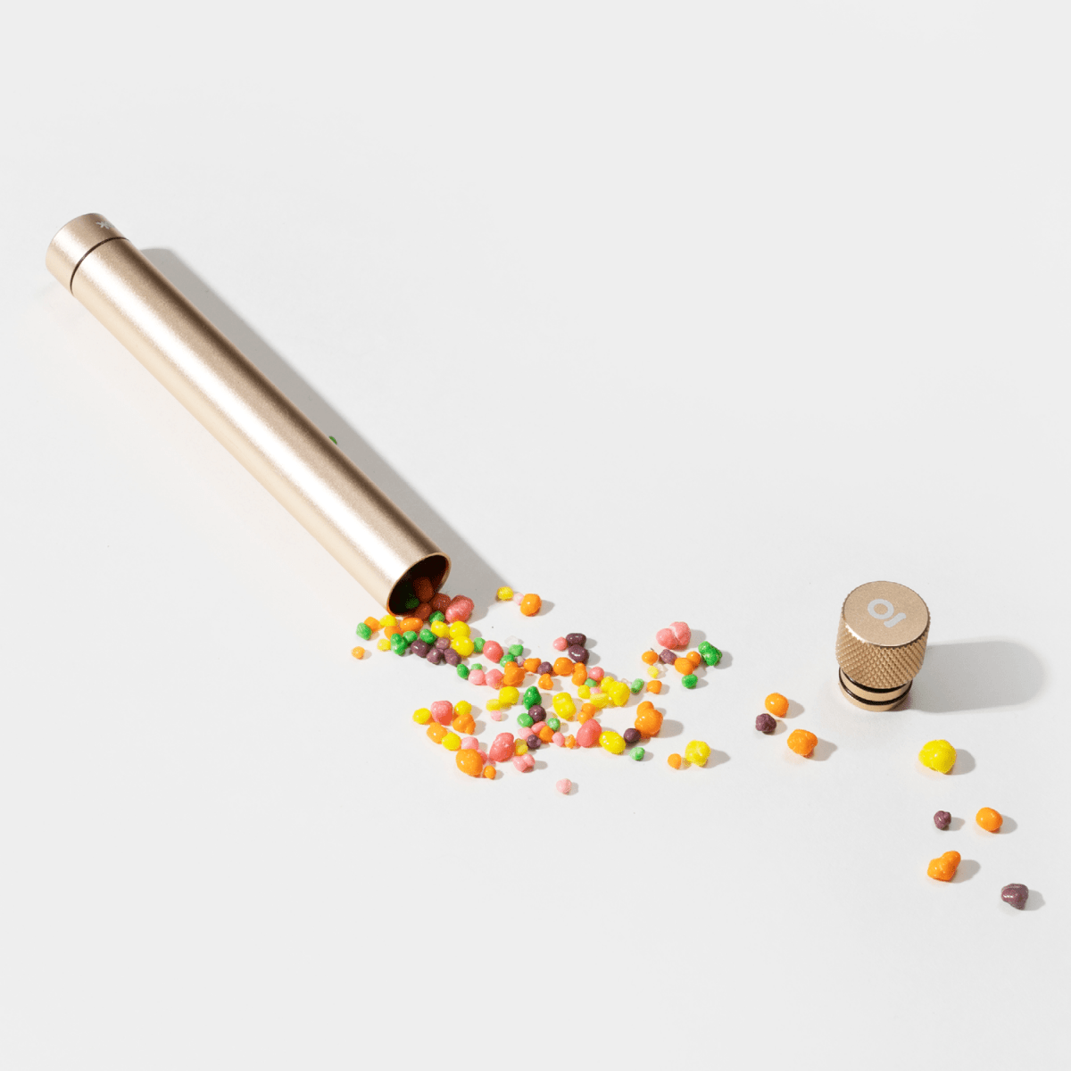 A spilled assortment of colorful candies flows from the open end of the Premium Storage Tube  Single, captured in a high-angle shot.