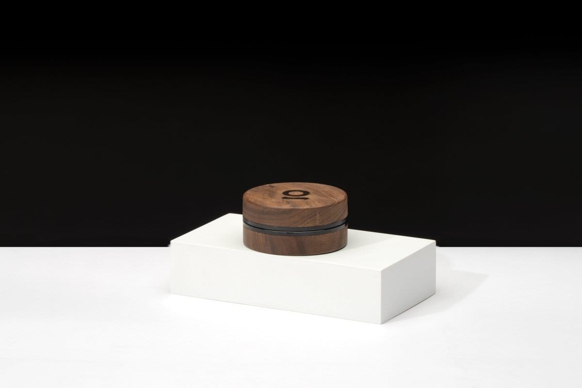 Front view of the 3 Inch, 2-Piece Walnut Grinder sitting on a white surface, showcasing its cylindrical shape and dark wood finish.