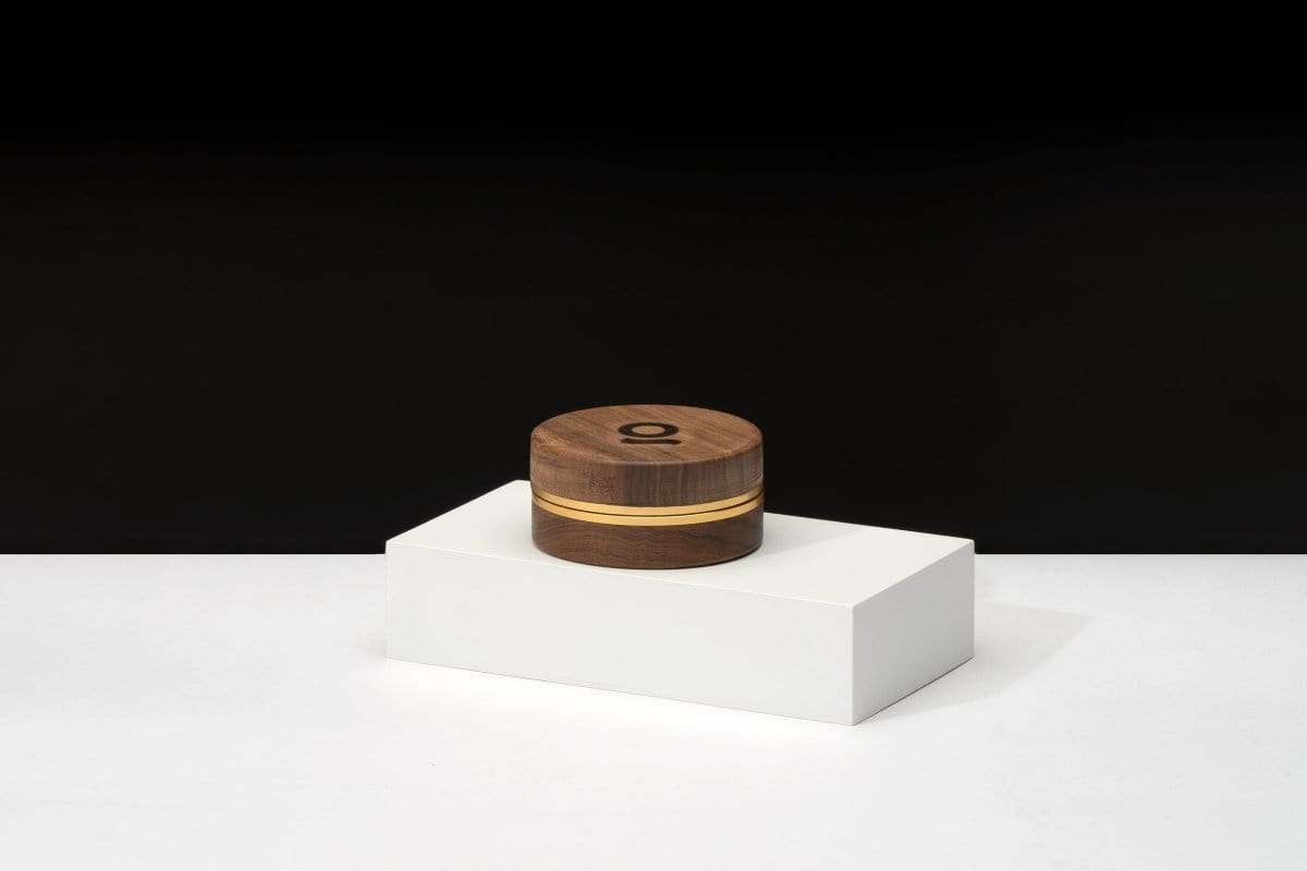 A centered, front view of the 3 Inch, 2-Piece Walnut Grinder resting on a white, minimalist platform.