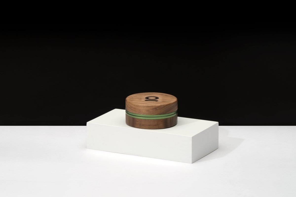 Front view of the 3 Inch, 2-Piece Walnut Grinder sitting atop a white block, highlighting its compact, cylindrical shape.