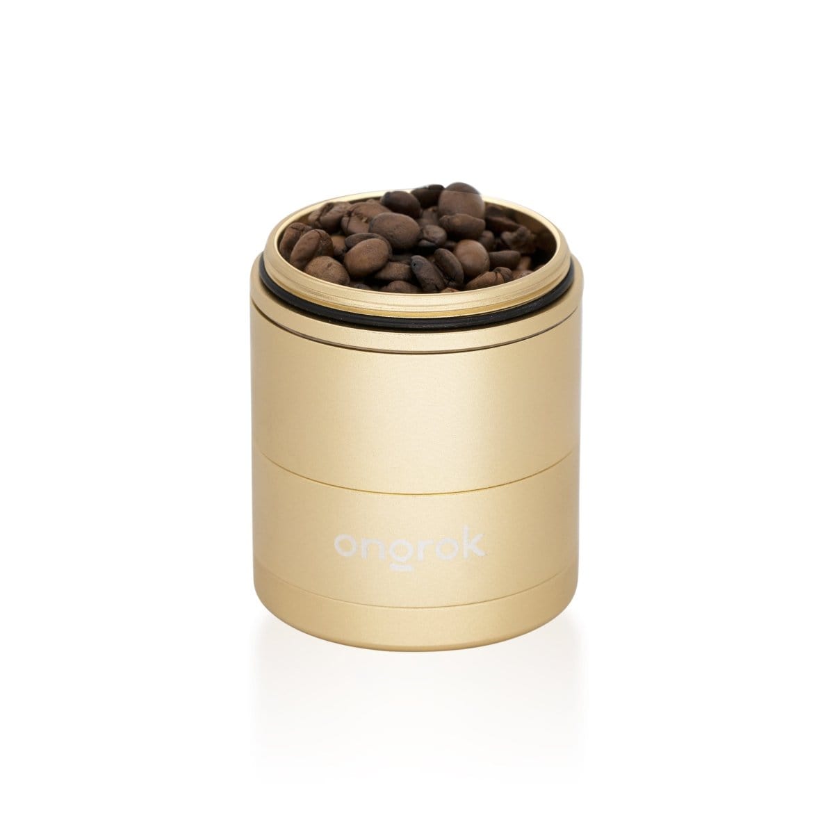 A close-up, angled view of the 5 Piece Storage Grinder, filled with dark contents, against a plain white background.