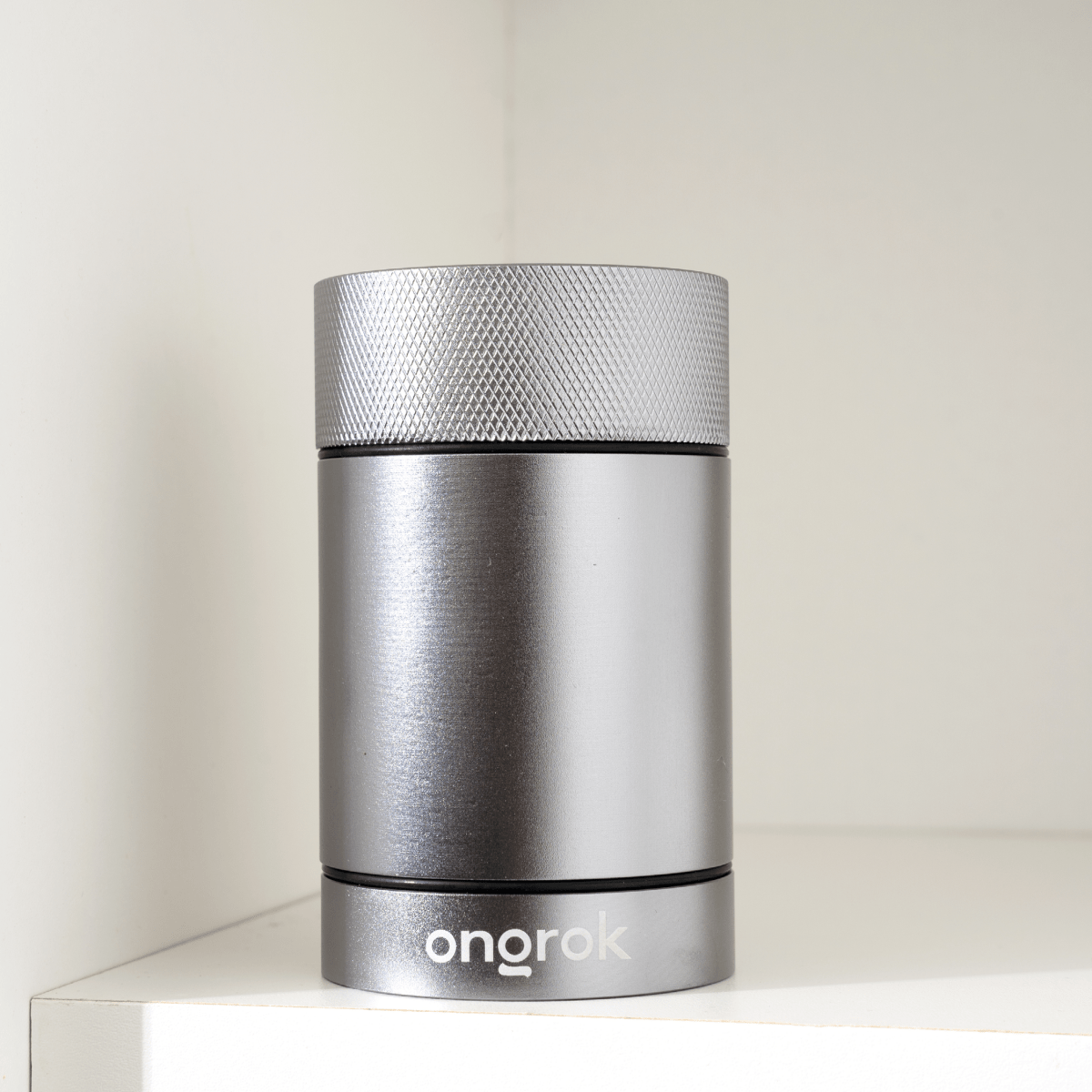 A front view of the Aluminum Metal Storage Jar, showcasing its sleek, cylindrical shape on a white surface.