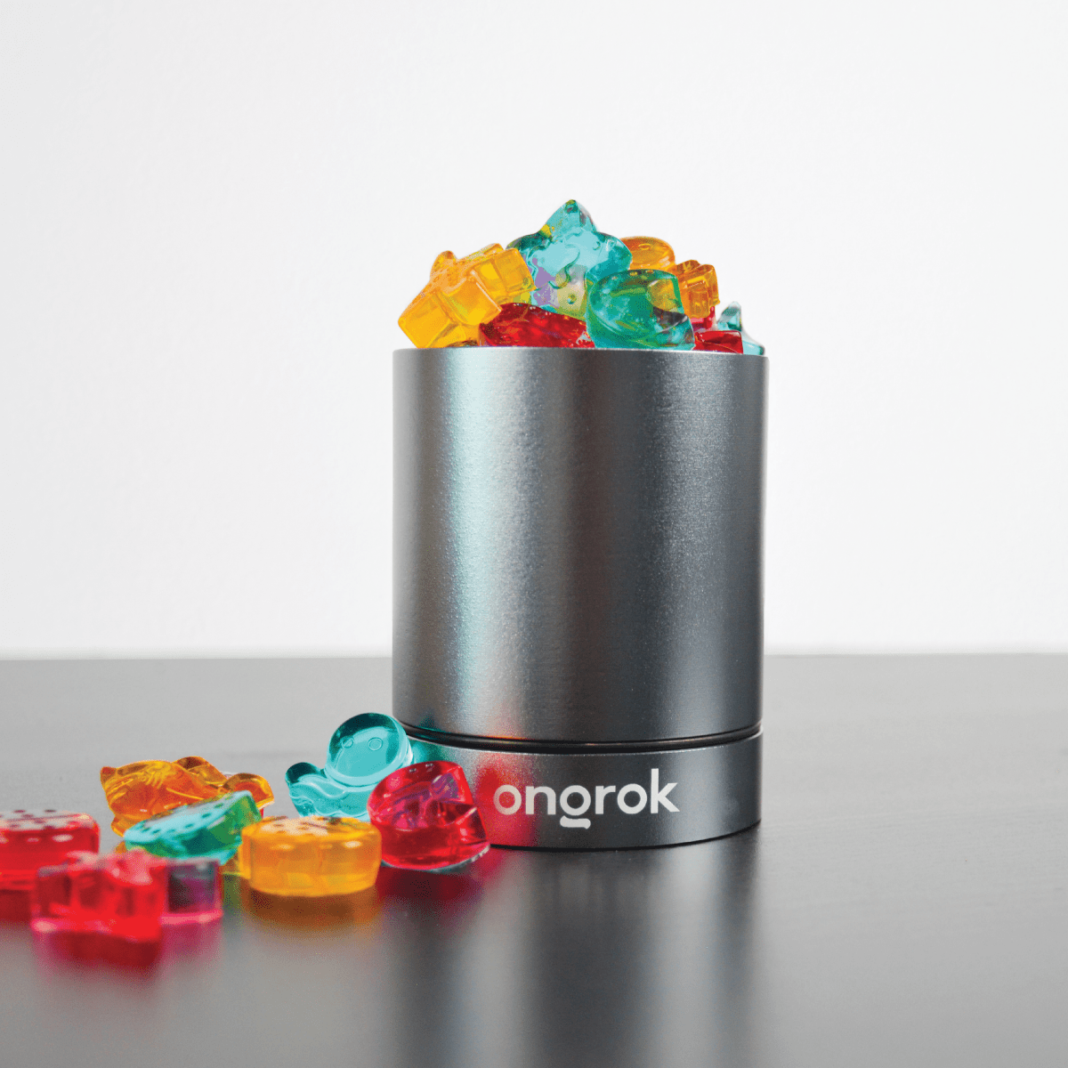 A front view of the Aluminum Metal Storage Jar filled with colorful candies, reflecting off its smooth metal surface.