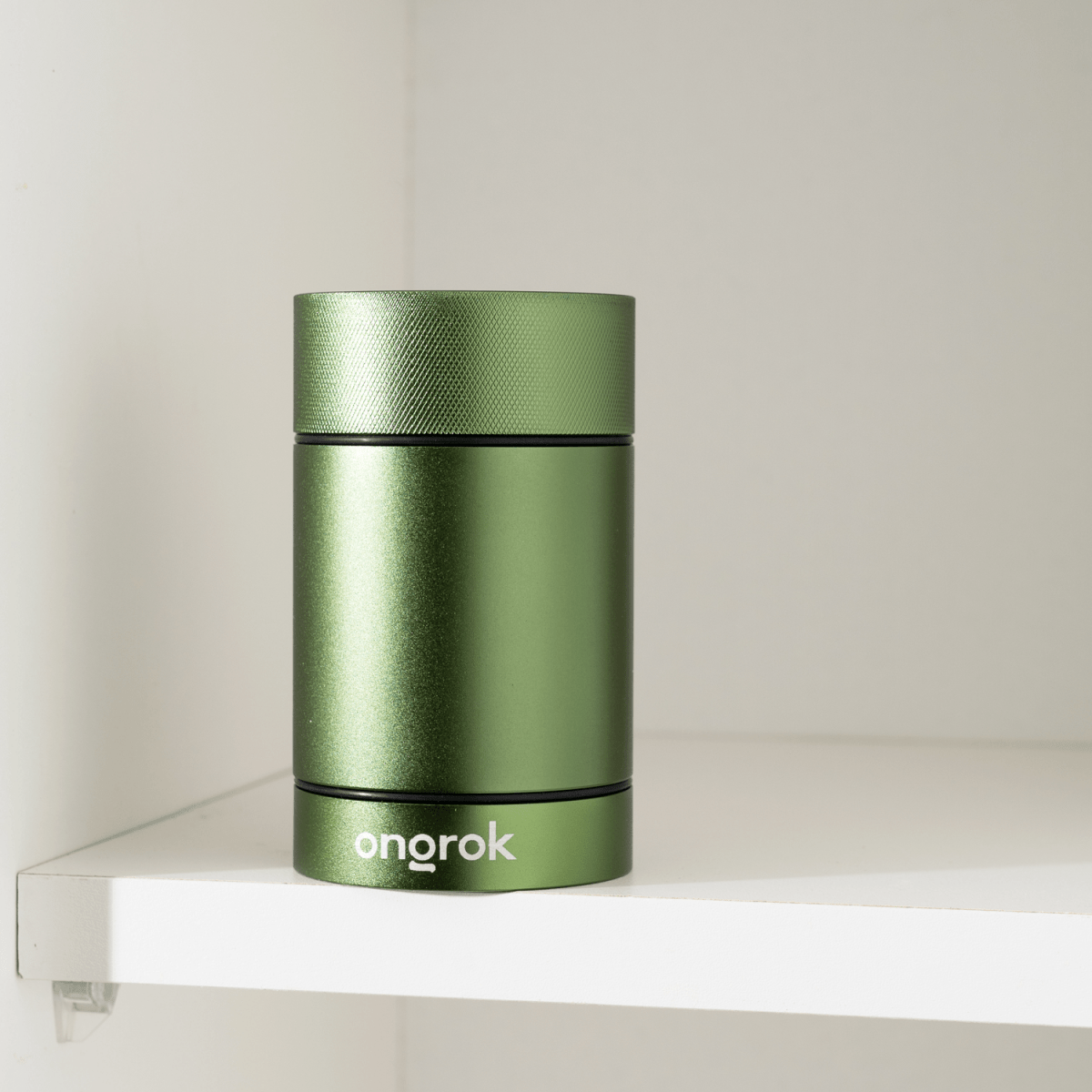 A low-angle view showcases the Aluminum Metal Storage Jar, its metallic finish contrasting with the white surface.