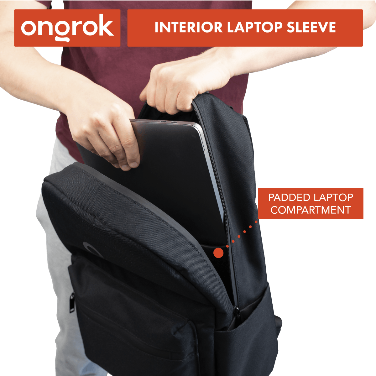 A slightly angled, medium shot displays the Carbon-lined Backpack on a person's hip, showcasing its sleek black exterior and zippered pocket.
